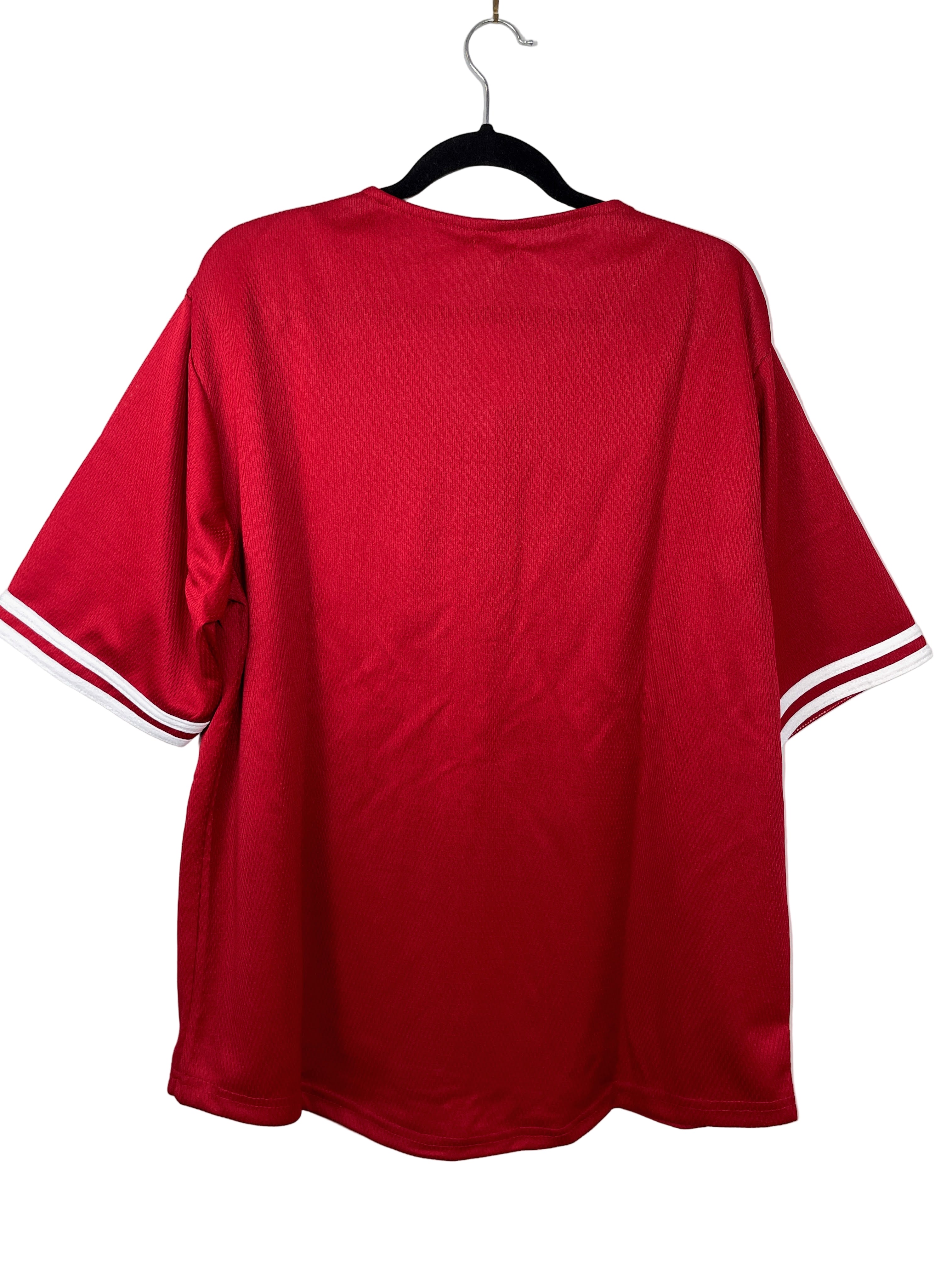 Red sports jersey with white accents on a hanger against a white background
