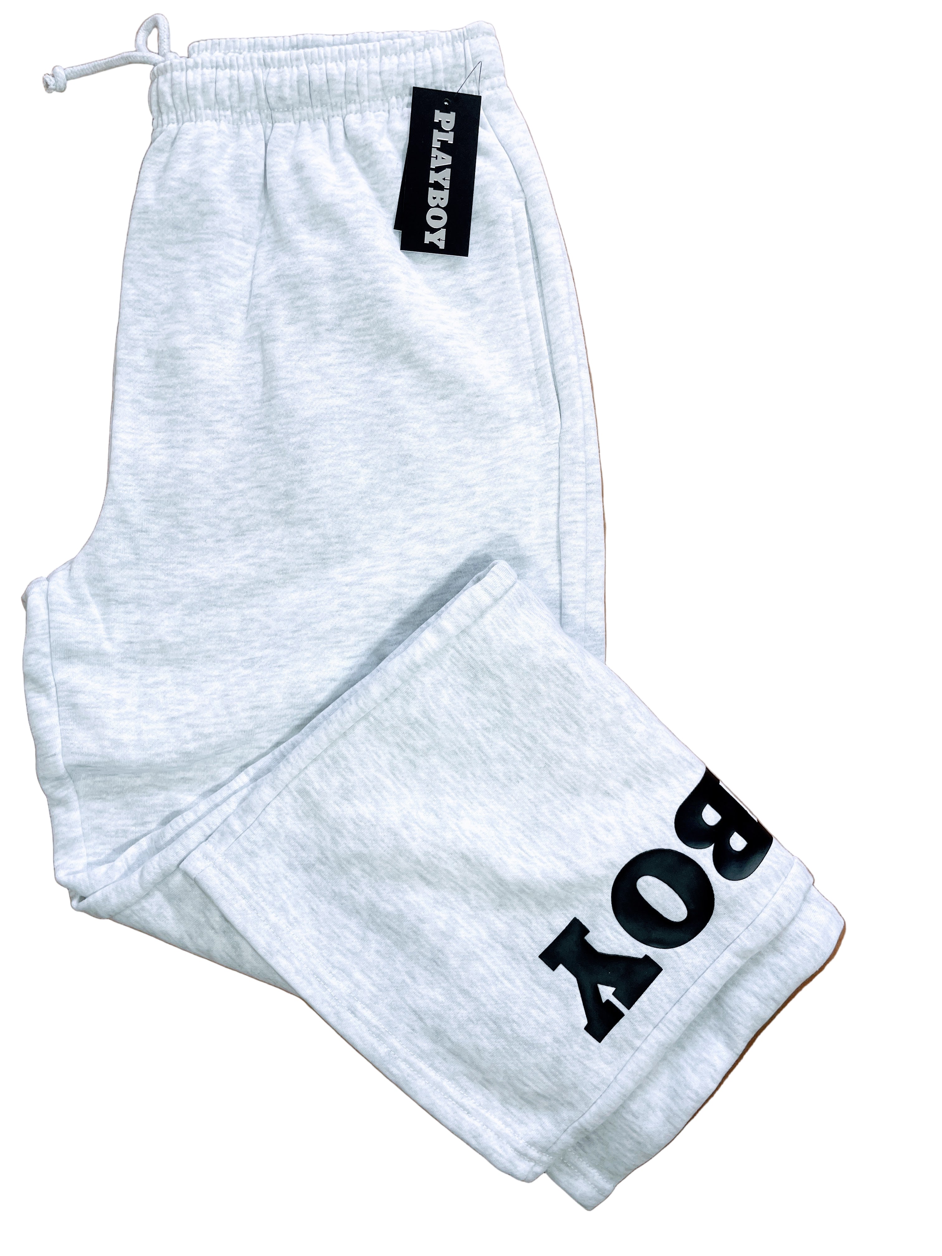 grey sweatpants with playboy text down the leg, folded with tags