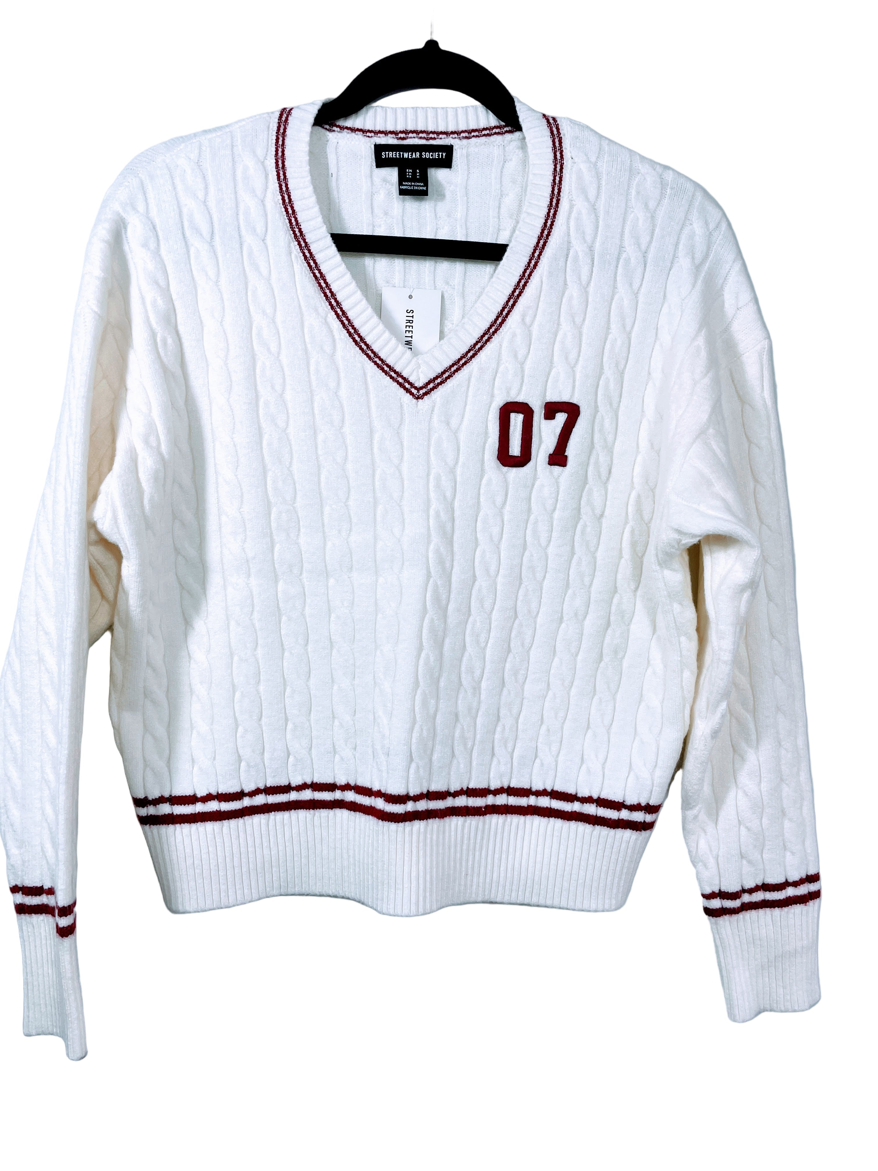 cream cable knit v-neck sweater with 07 patch front