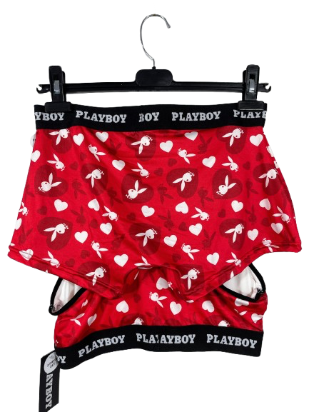Red boxer briefs with white bunny and heart designs on a hanger with Playboy branding.
