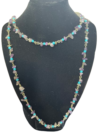 Necklace with multicolored beads on a black mannequin bust