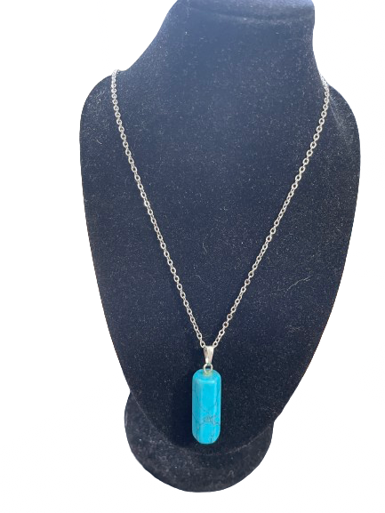 Turquoise pendant necklace on a black bust