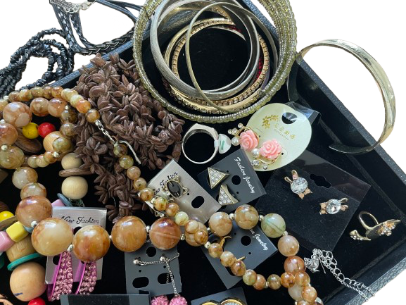 Assorted jewelry including bracelets, necklaces, and earrings on a white background