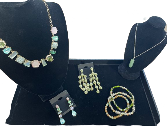 Jewelry set including necklace, earrings, and bracelet on a black stand with a white background.