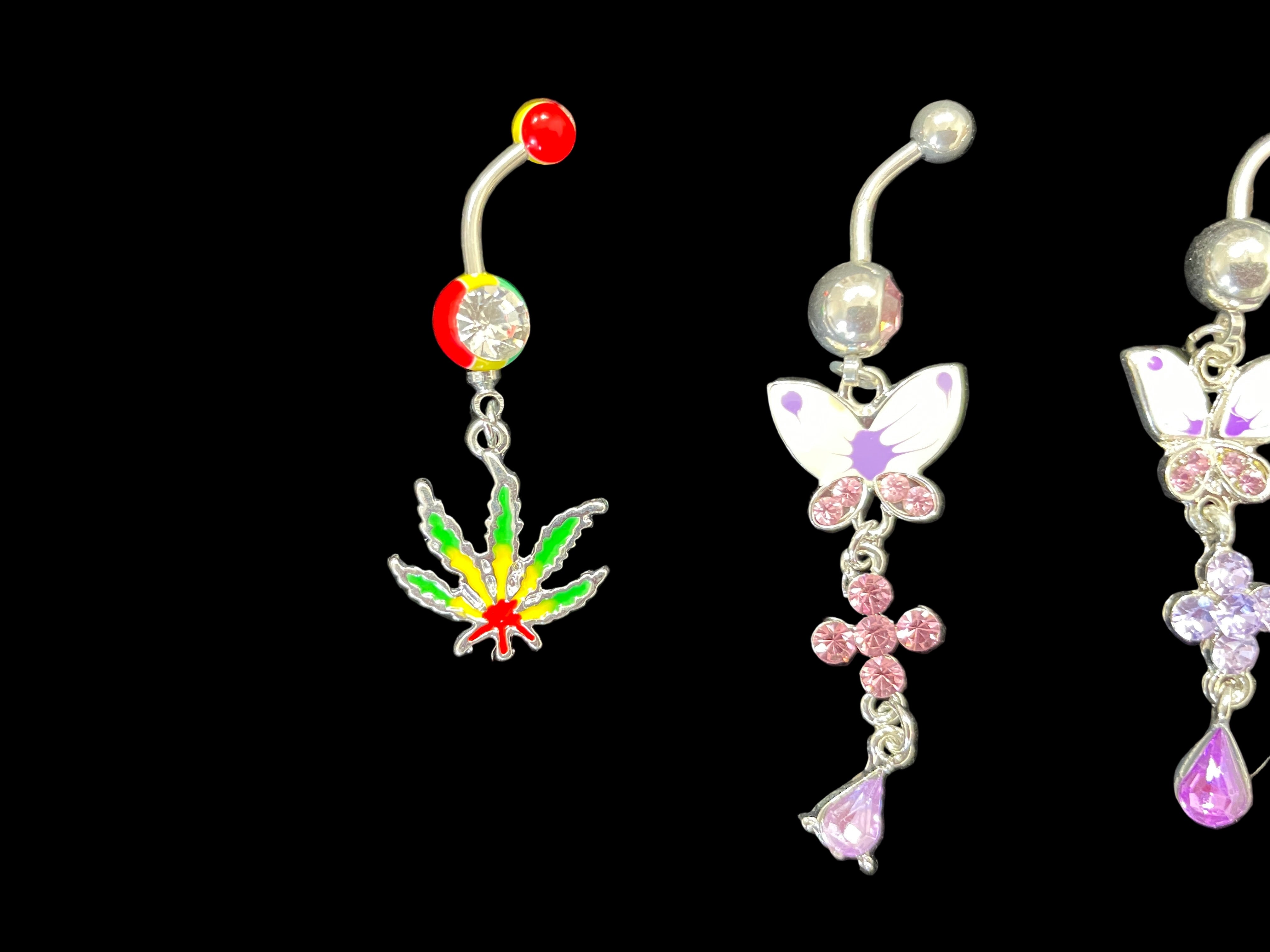 Navel rings with colorful designs on a black background