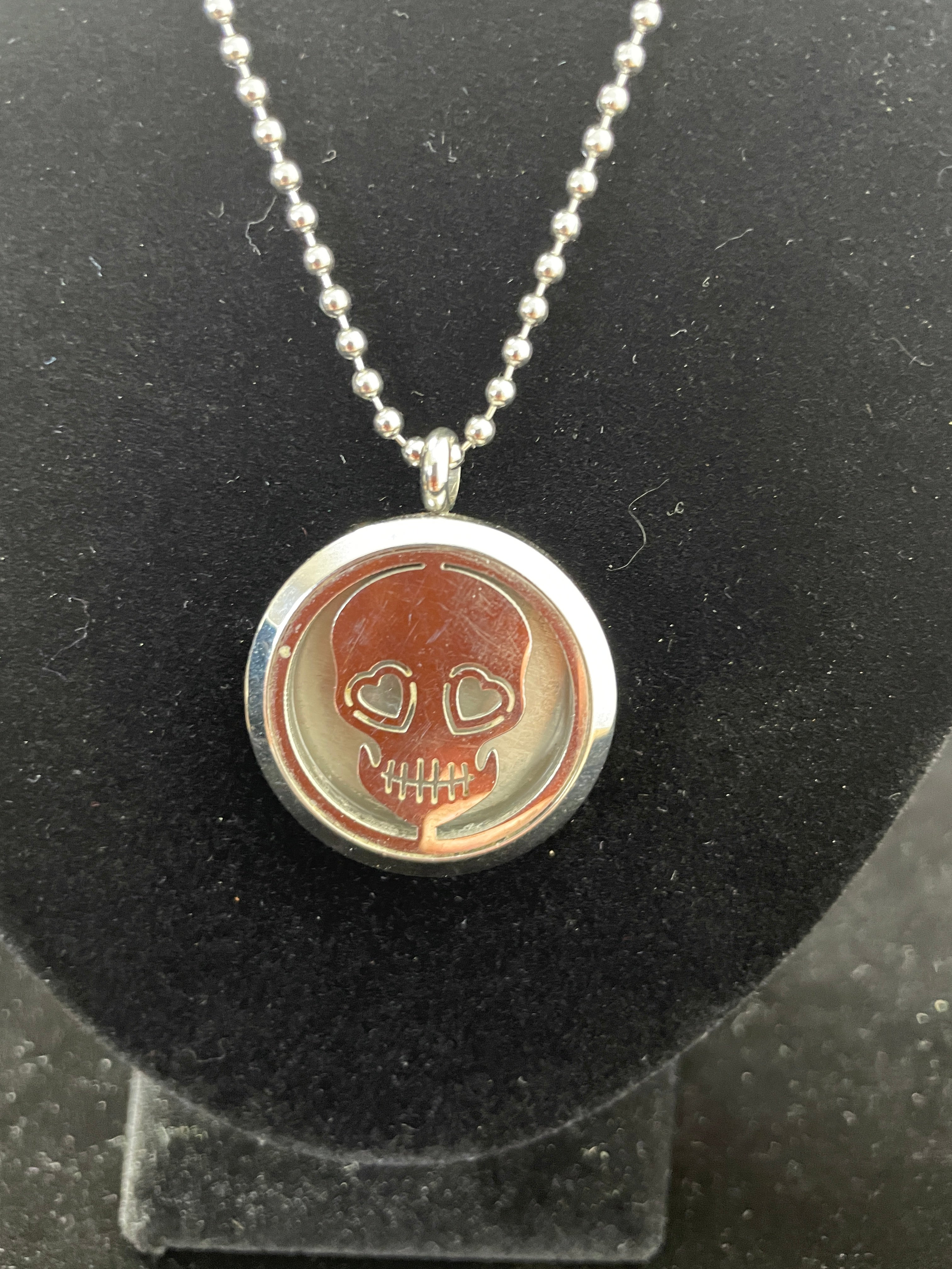 Silver skull locket necklace with heart eyes on ball chain