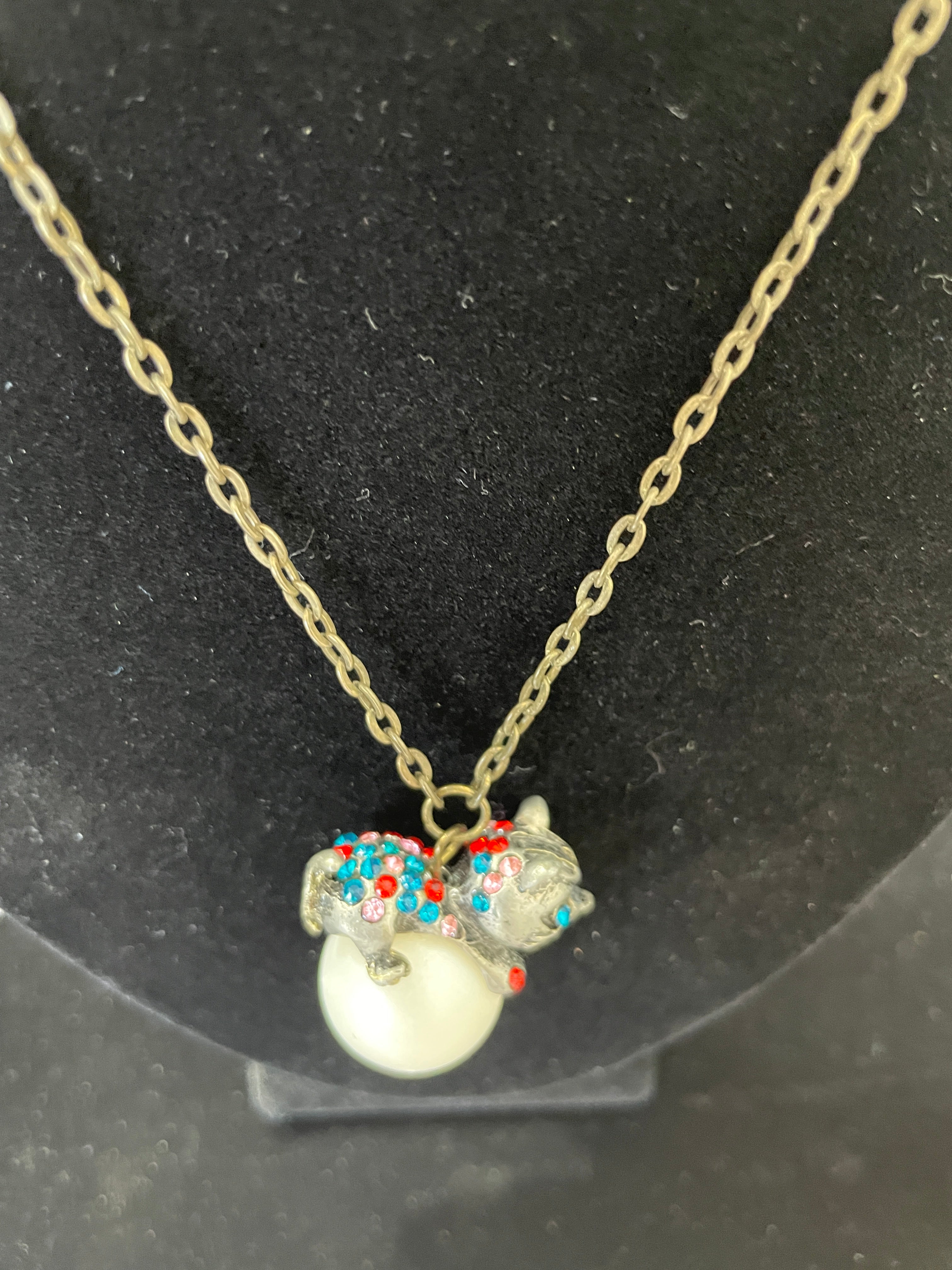 necklace with cat perched on a pearl