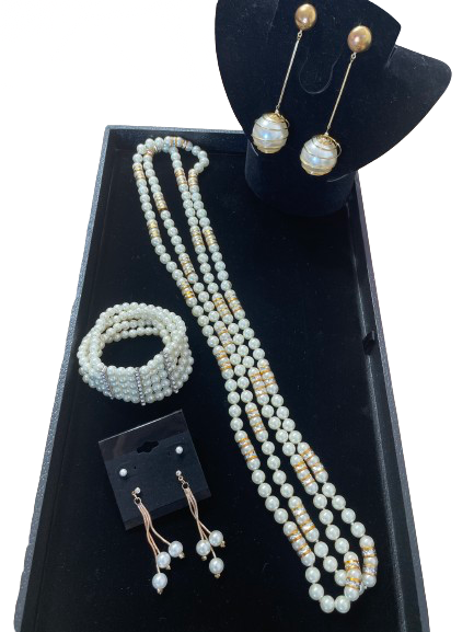 Faux pearl jewellery set with long necklace, bracelet, and earrings