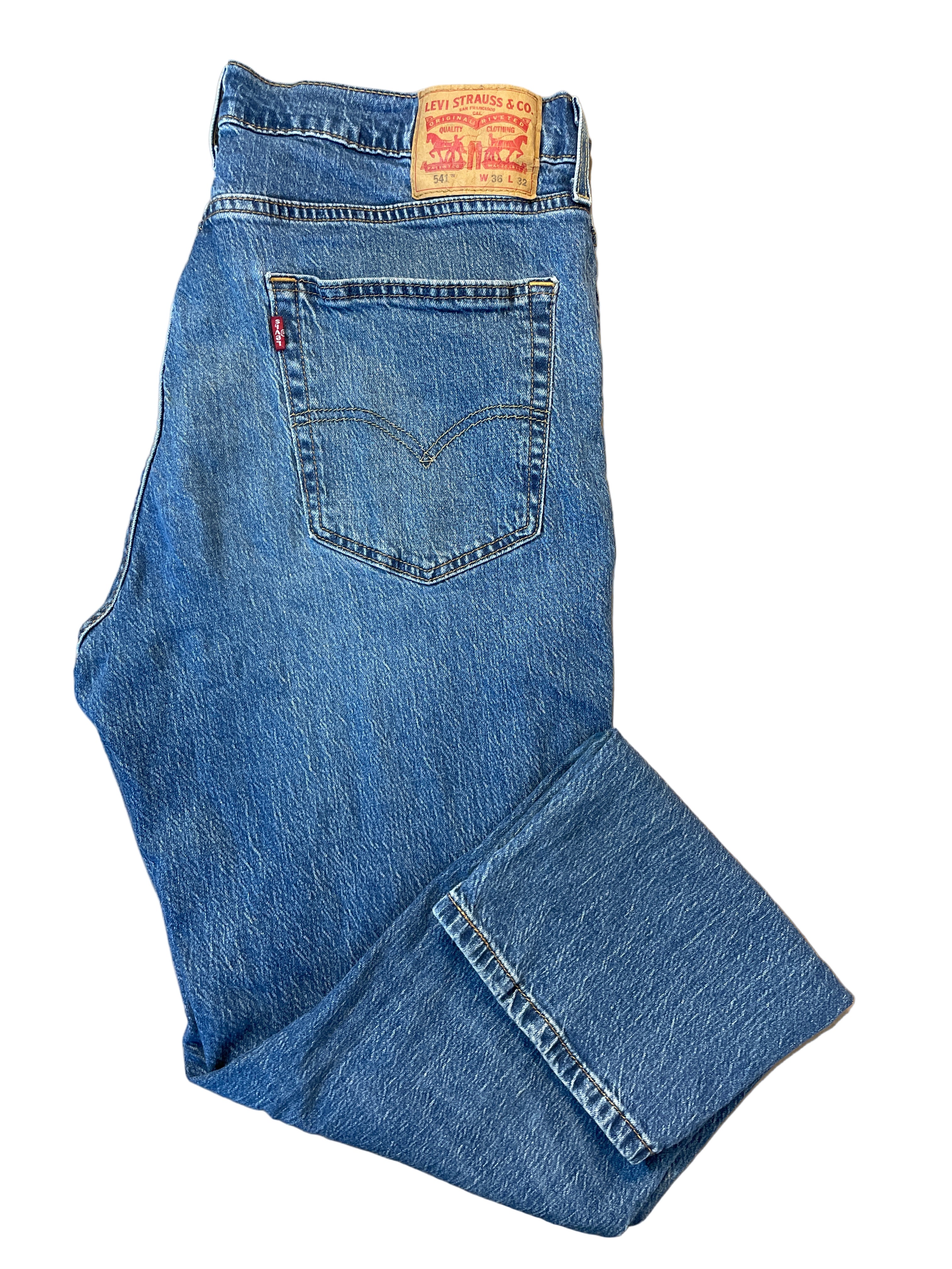 Folded view of Levi’s 541 medium wash men’s jeans with back patch and red tab