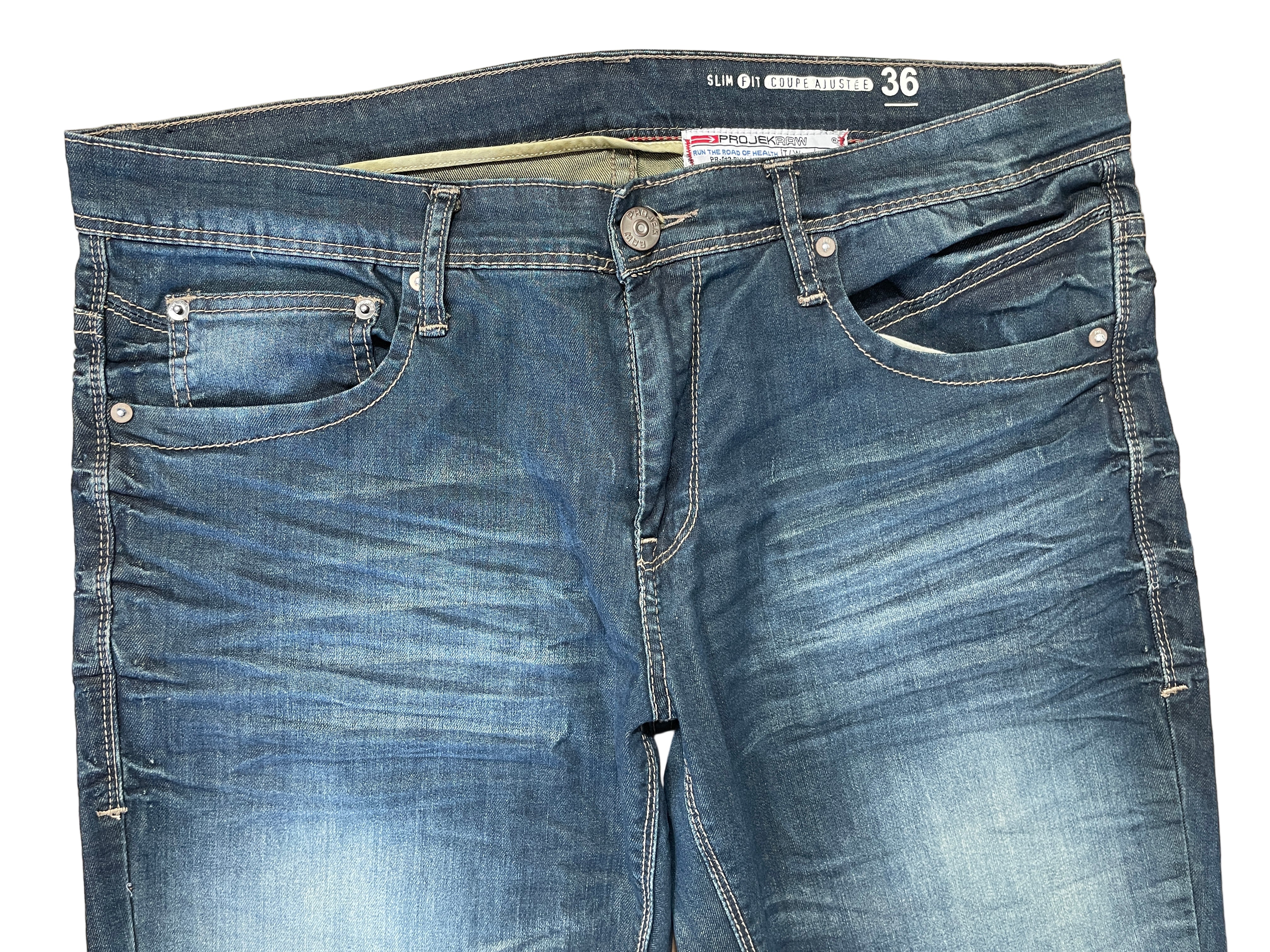Front view of Projek Raw jeans showing zipper fly and pockets