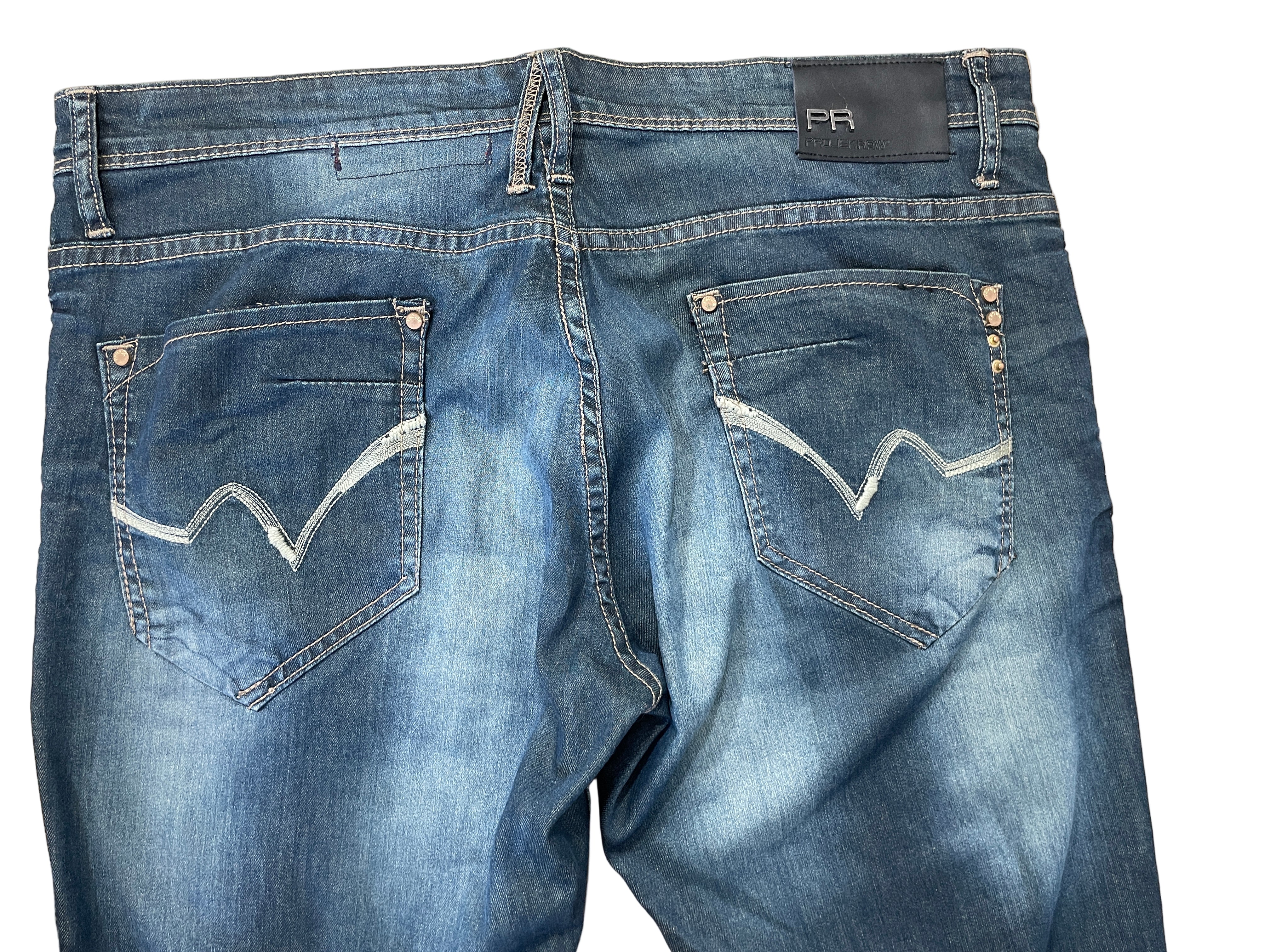 Back view of Projek Raw jeans with embroidery and stud details on pockets