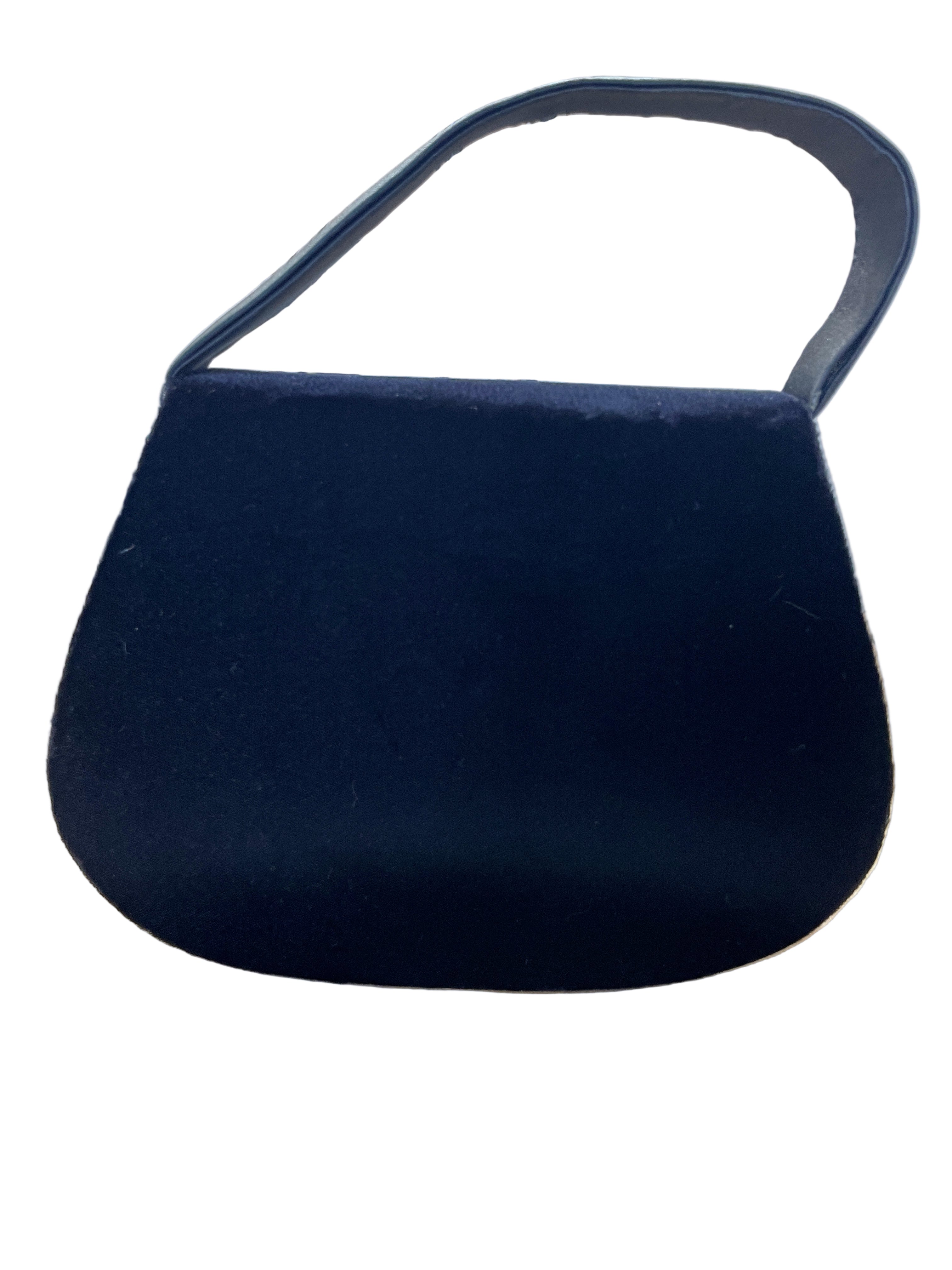 Back view of black velvet evening bag with single handle
