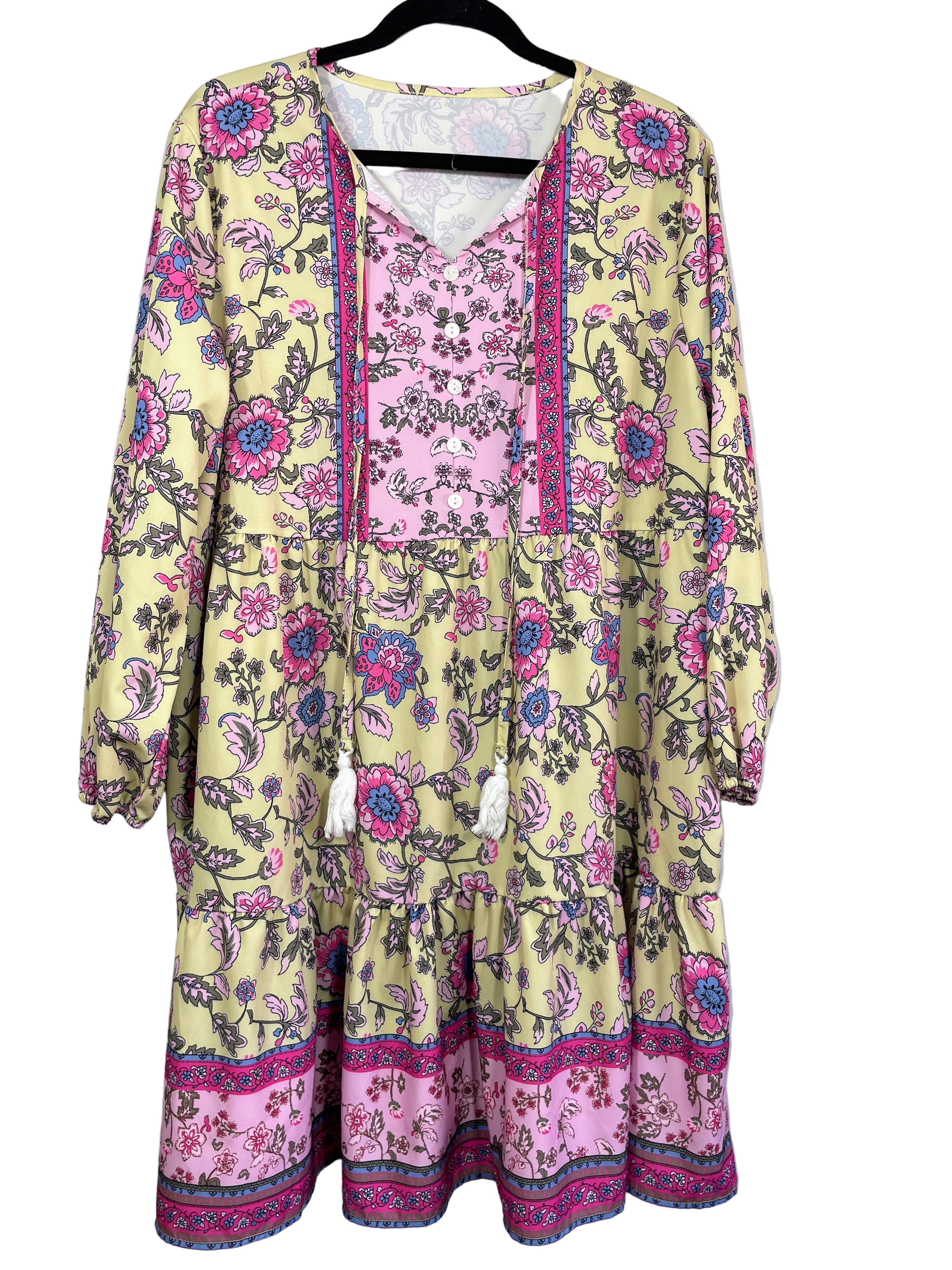 Front view of yellow floral boho dress with tassel ties and border print