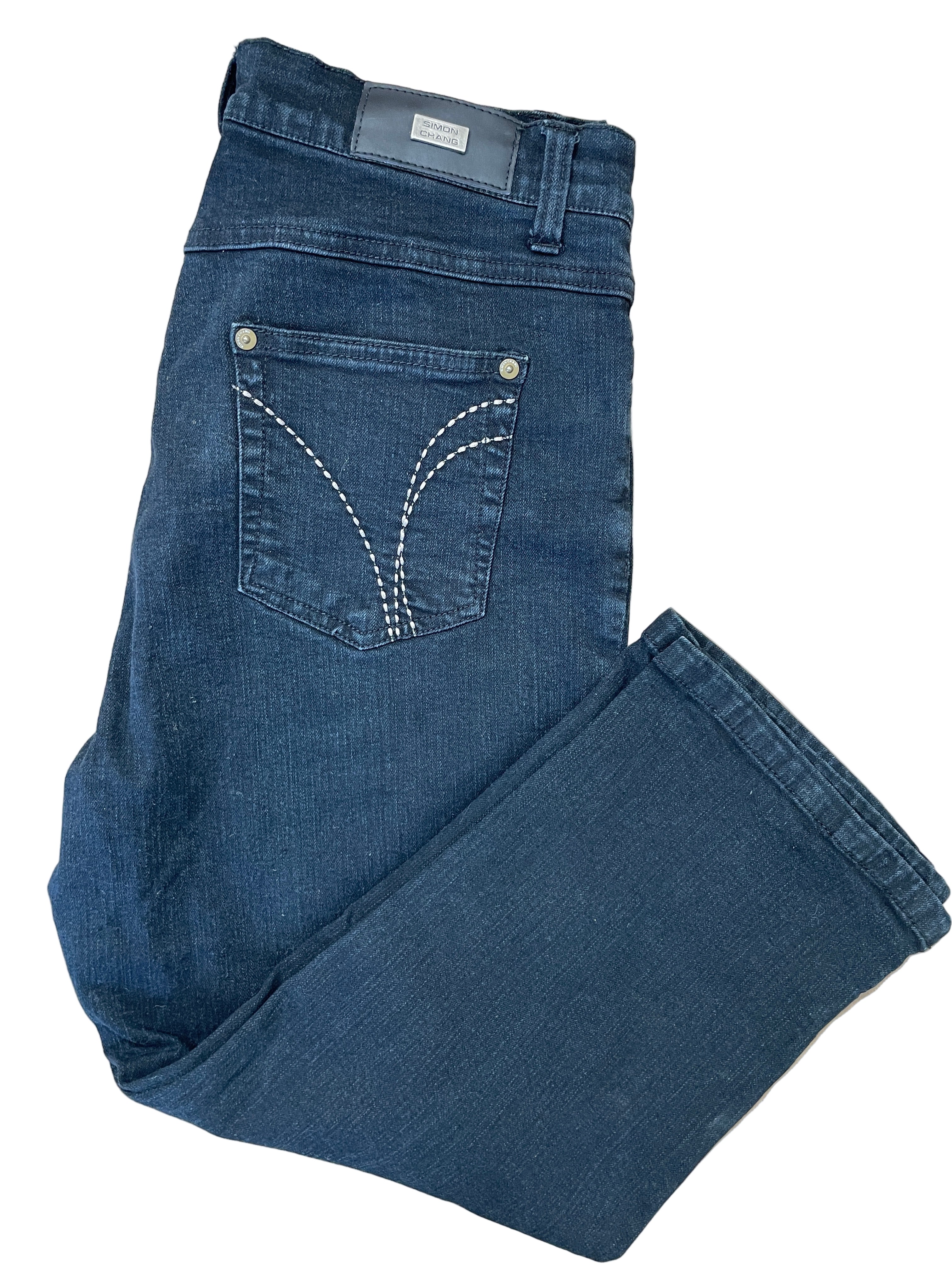 Folded view of Simon Chang black denim capris with stitched back pocket detail