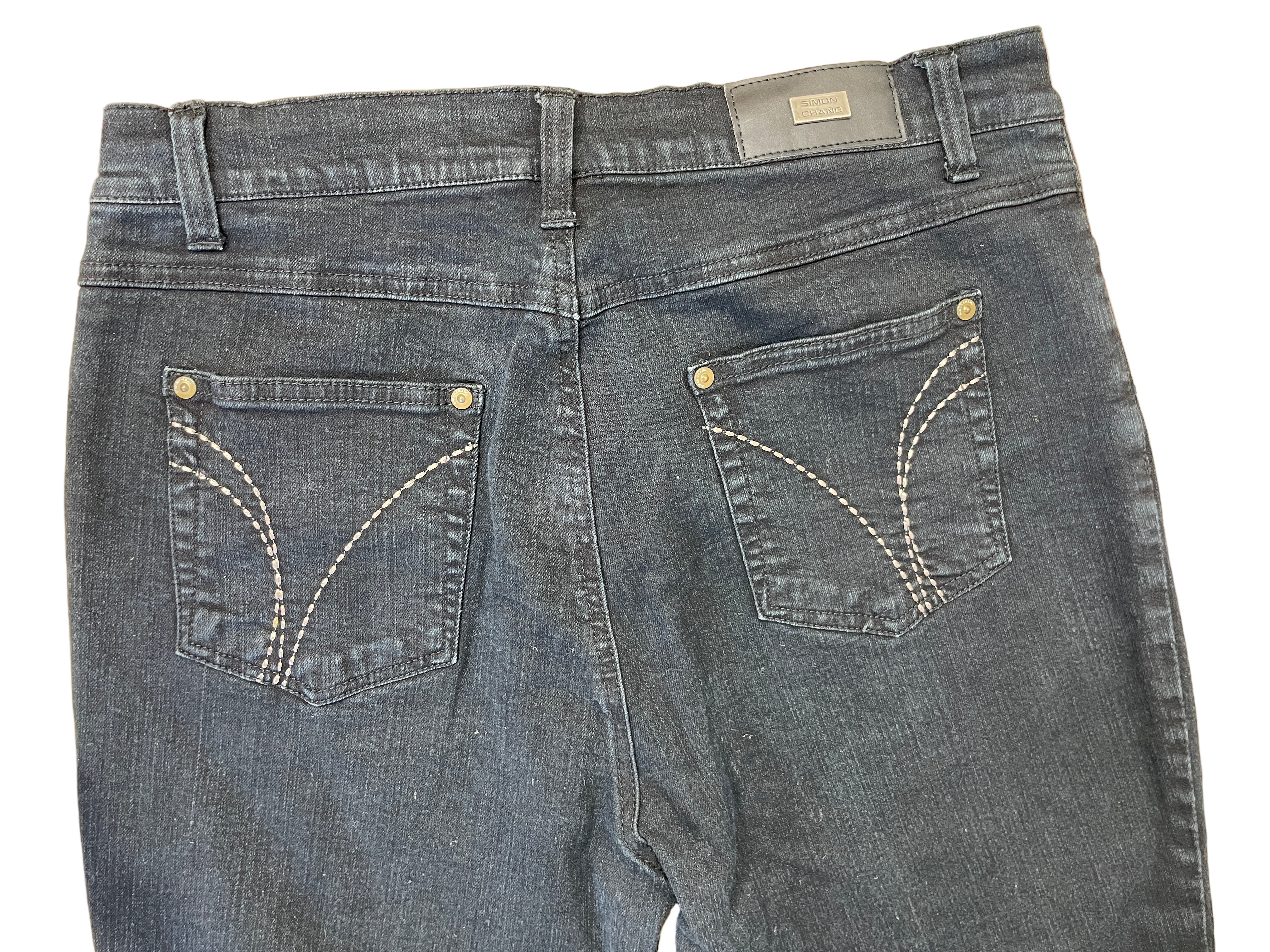 Back view of Simon Chang black denim capris with contrast stitching on pockets