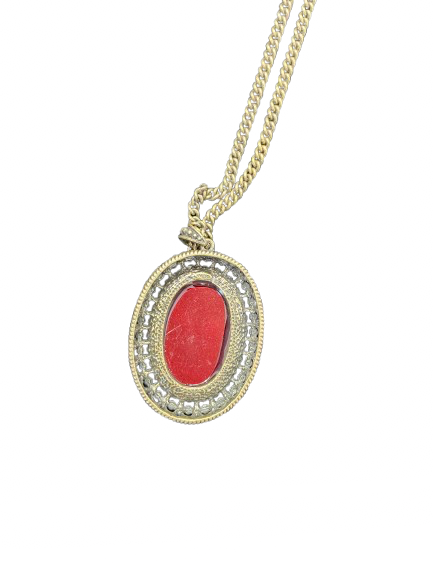 Gold necklace with a red pendant on a white background