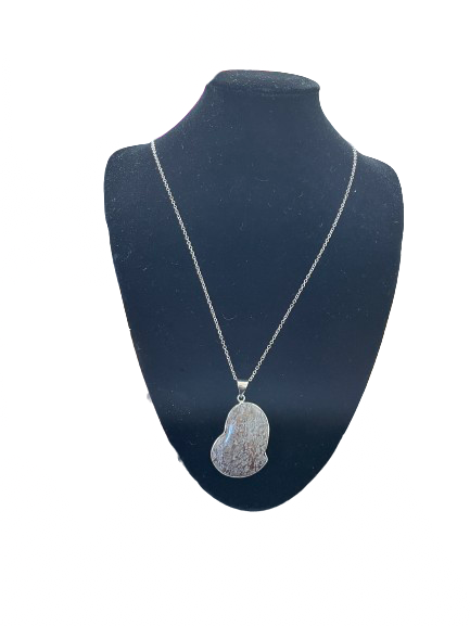 Silver necklace with a pendant on a black mannequin bust against a white background