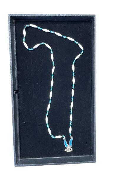 Necklace with blue and white beads in a black display box