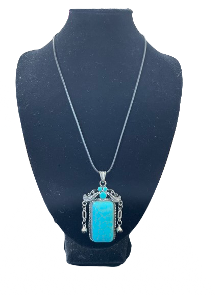 Turquoise pendant necklace on display stand
