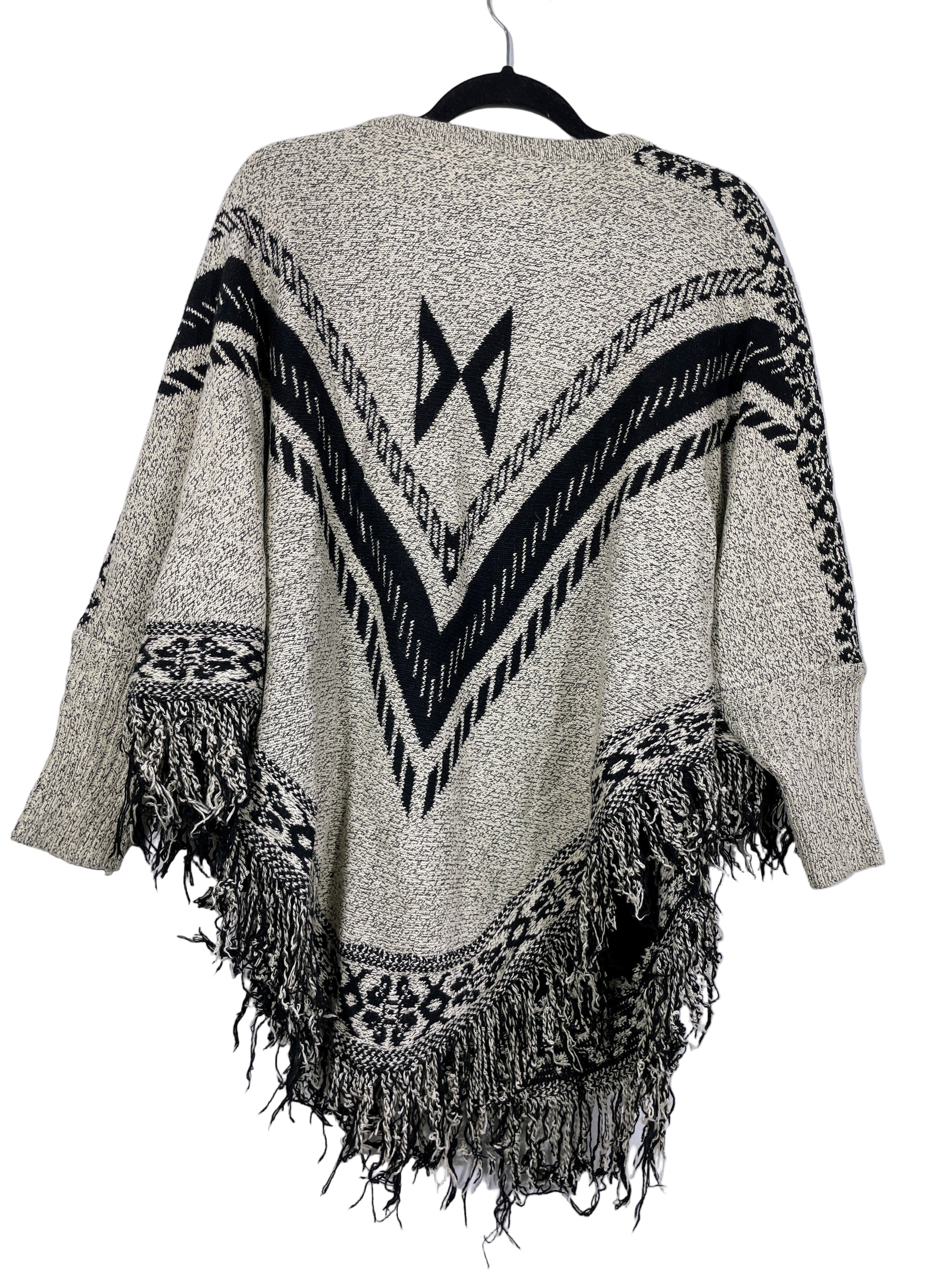 Sweater poncho back view with geometric knit pattern