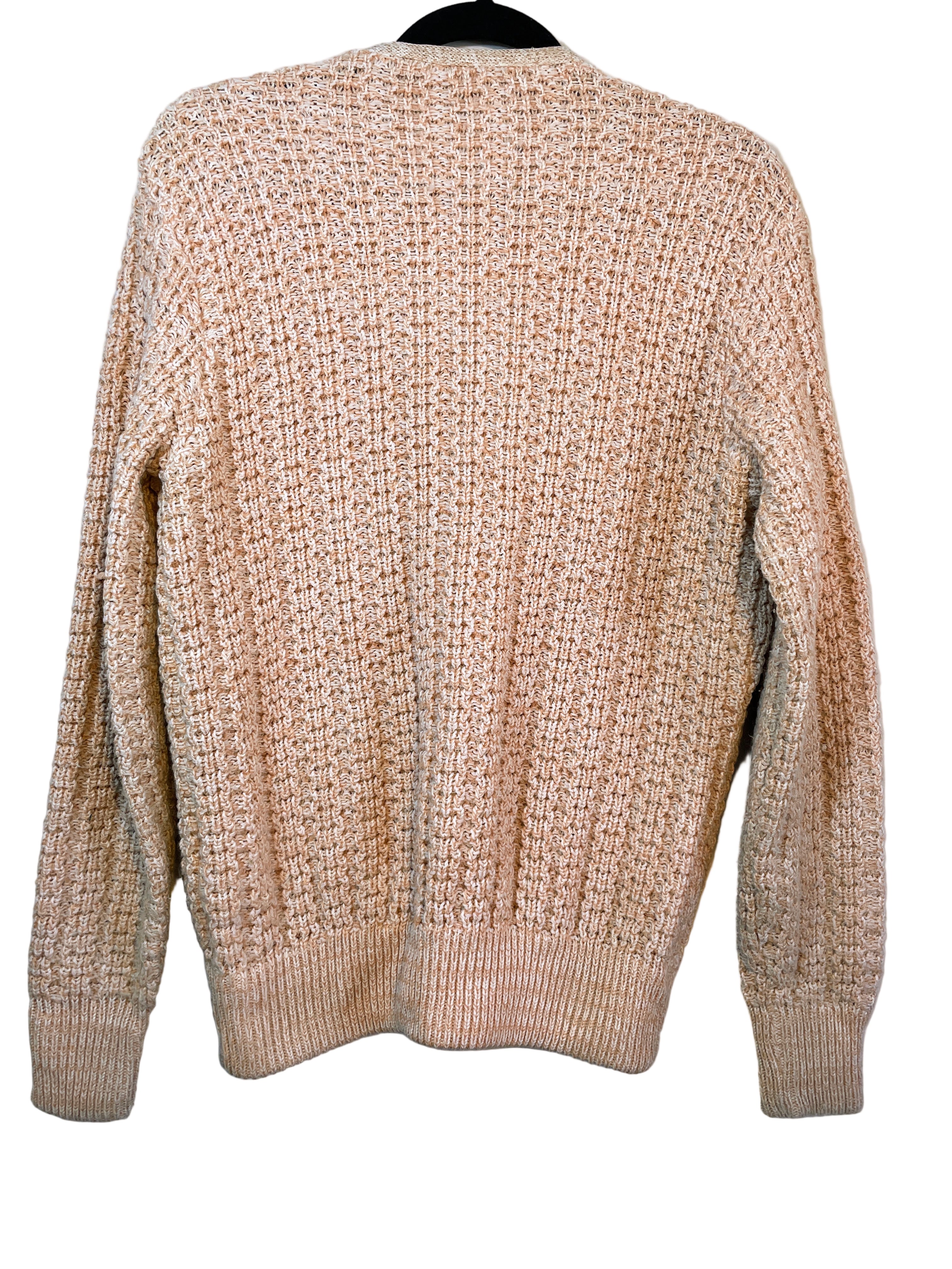 Back view of textured peach and beige knit cardigan showing waffle pattern.