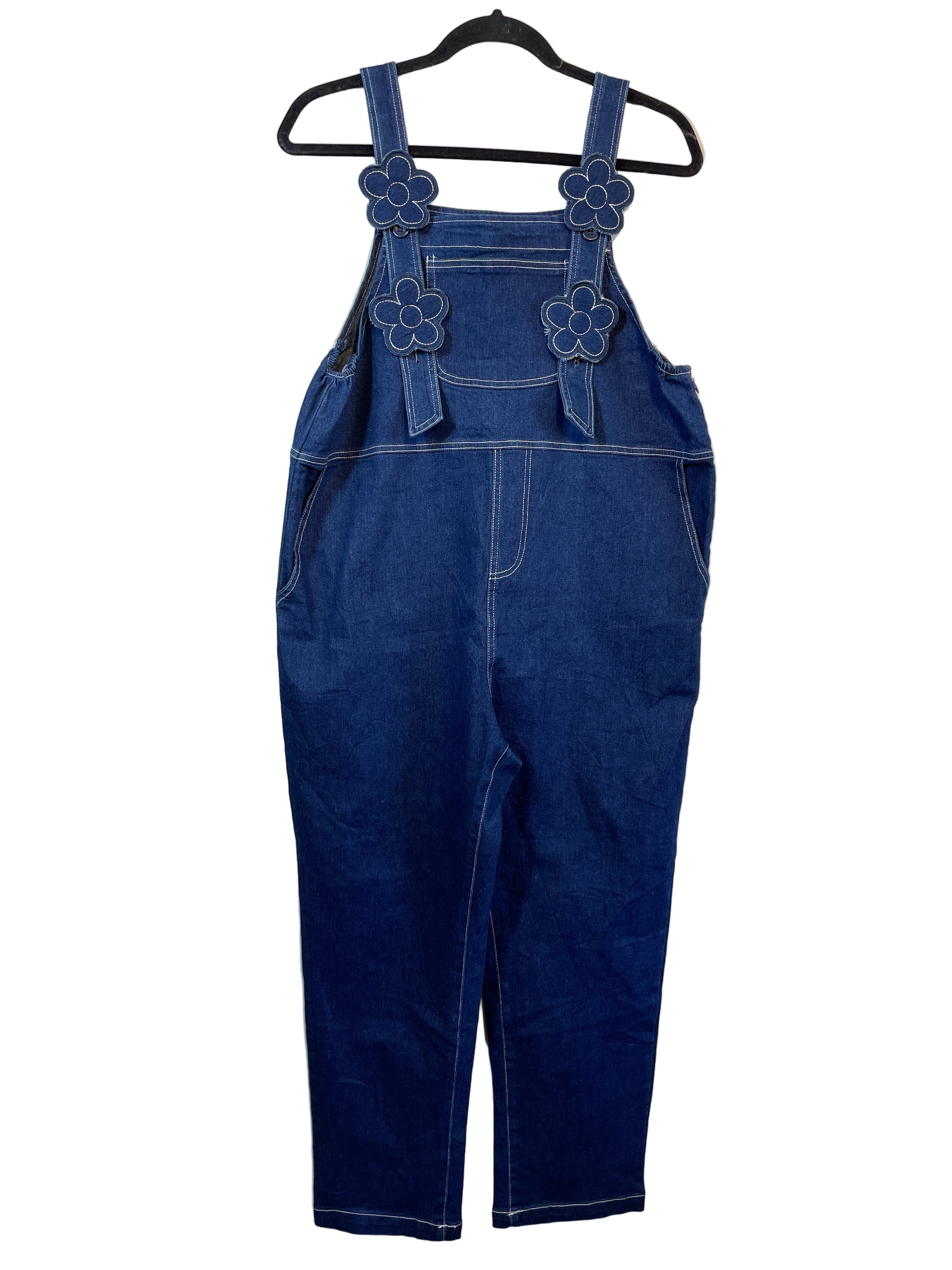 Front view of Minimami dark denim overalls with daisy strap accents on hanger.
