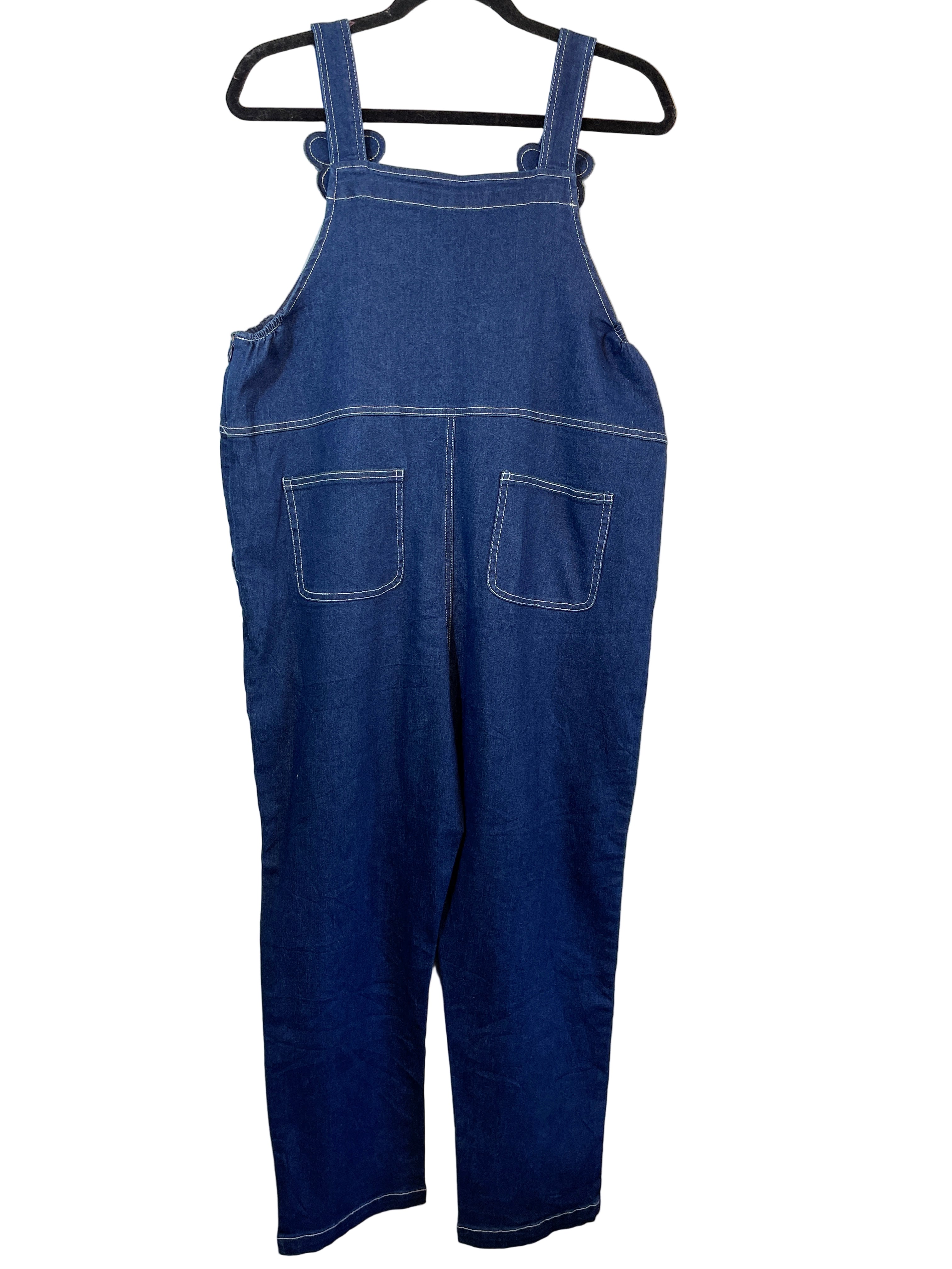 Back view of Minimami dark denim overalls showing patch pockets and elastic sides.
