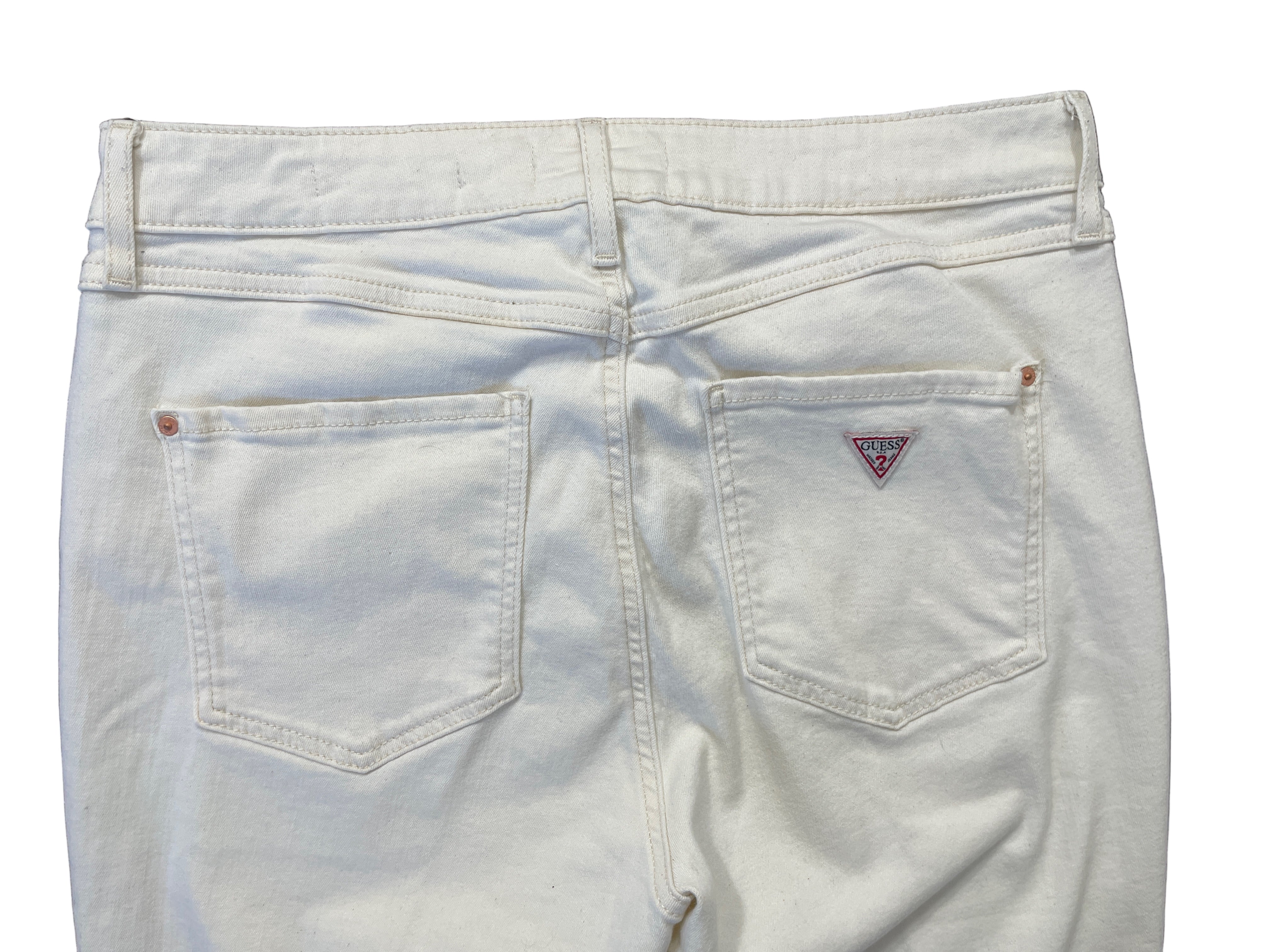 Back view of cream GUESS 1981 skinny jeans with signature triangle logo on pocket.
