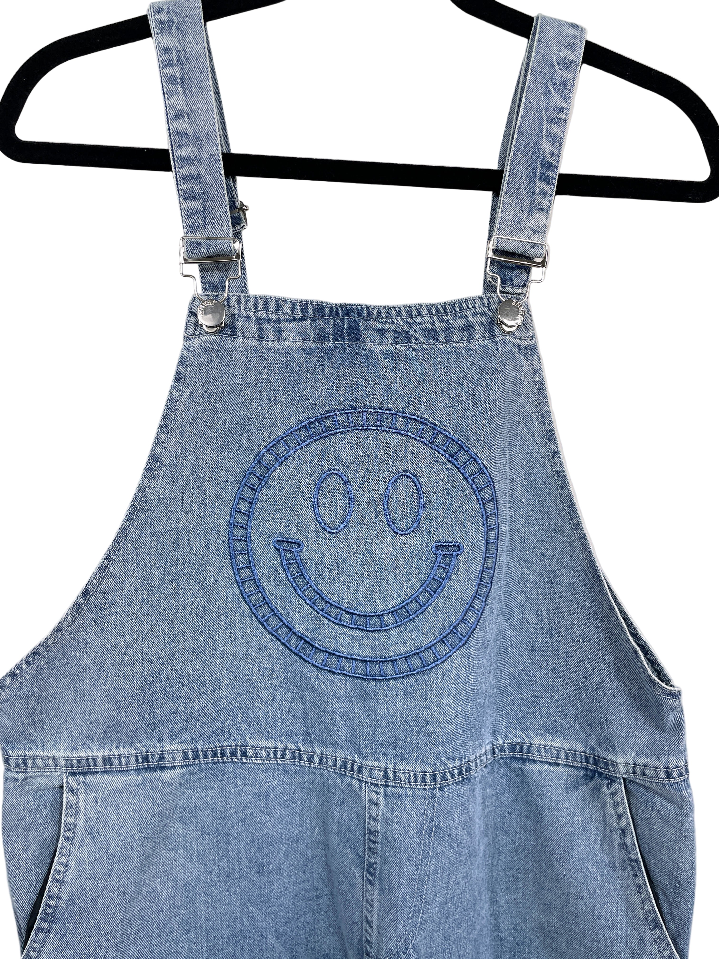 Blue denim apron with smiley face design on a white background