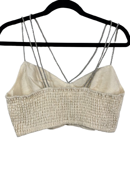 Back view of H&M beige crop top showing smocked elastic panel and glittery straps.