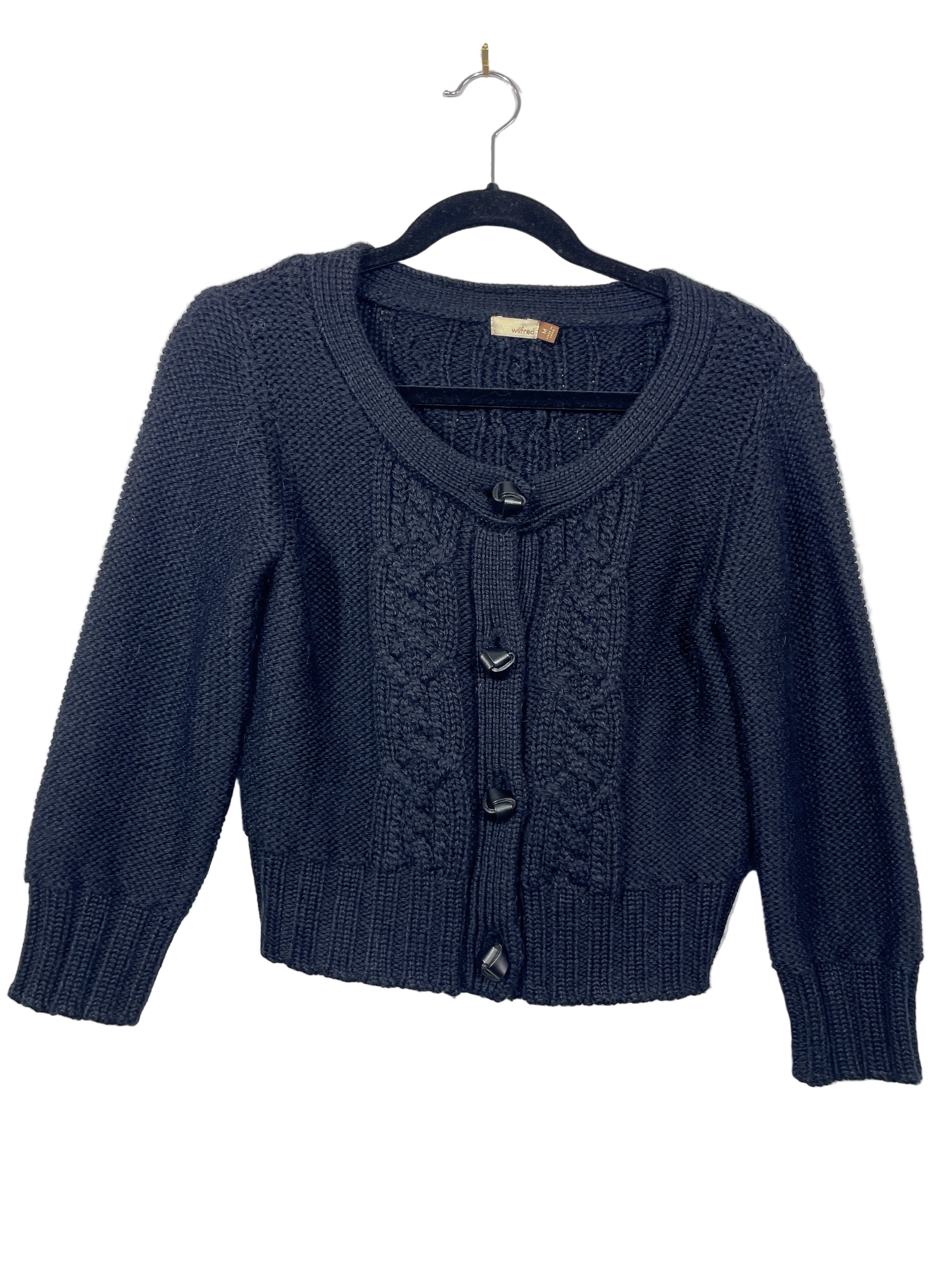 Front view of Aritzia Wilfred black cropped knit cardigan with cable knit design and buttons.
