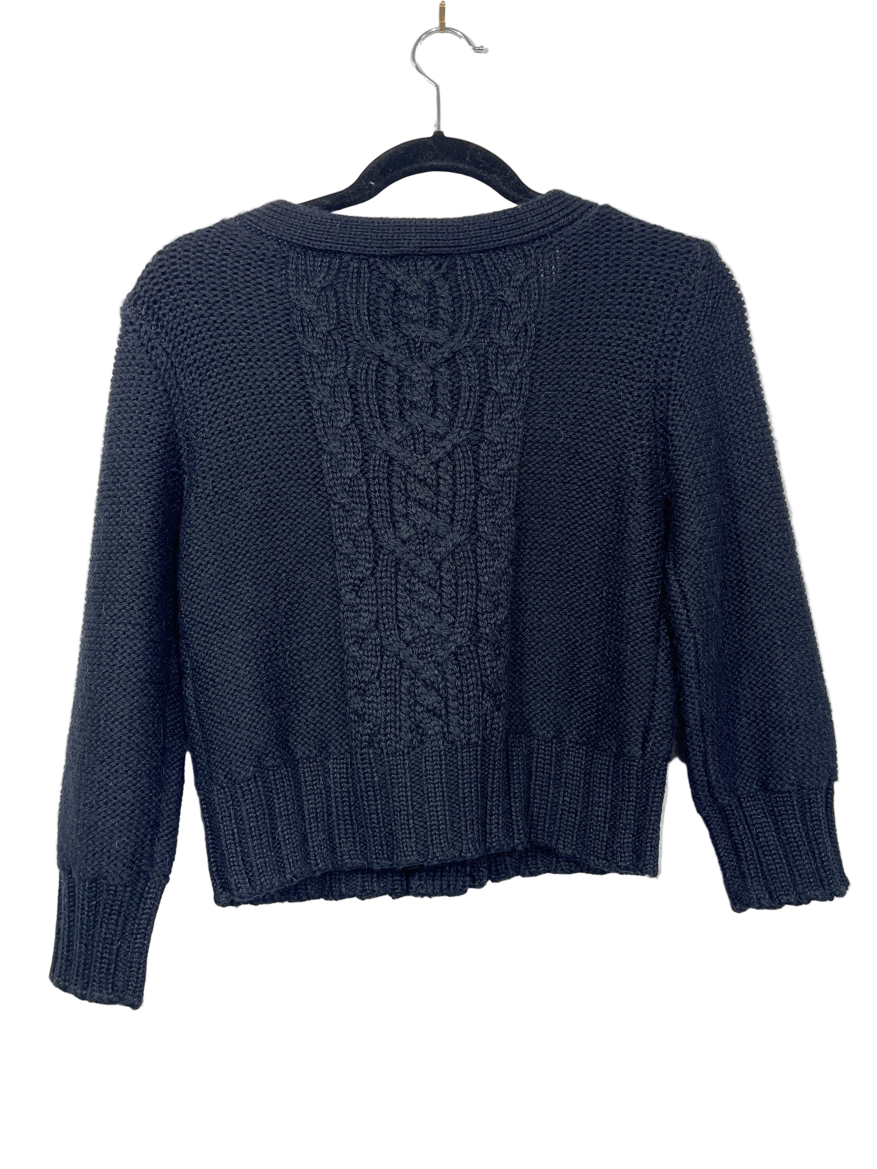 Back view of Aritzia Wilfred cropped black cardigan showing cable pattern and ribbed hem.

