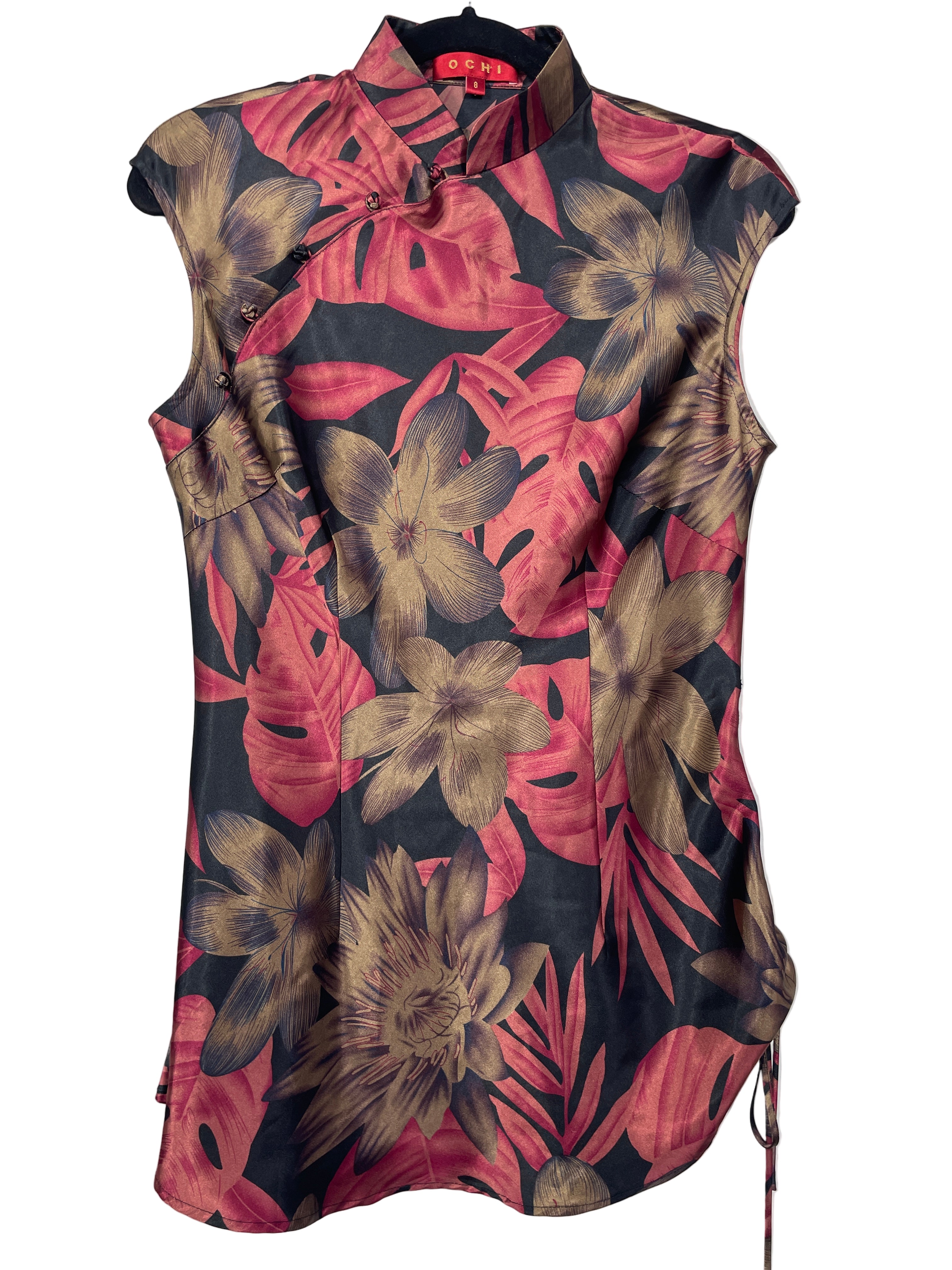 Front view of OCHI sleeveless silk blouse with red and bronze floral print and frog closures.
