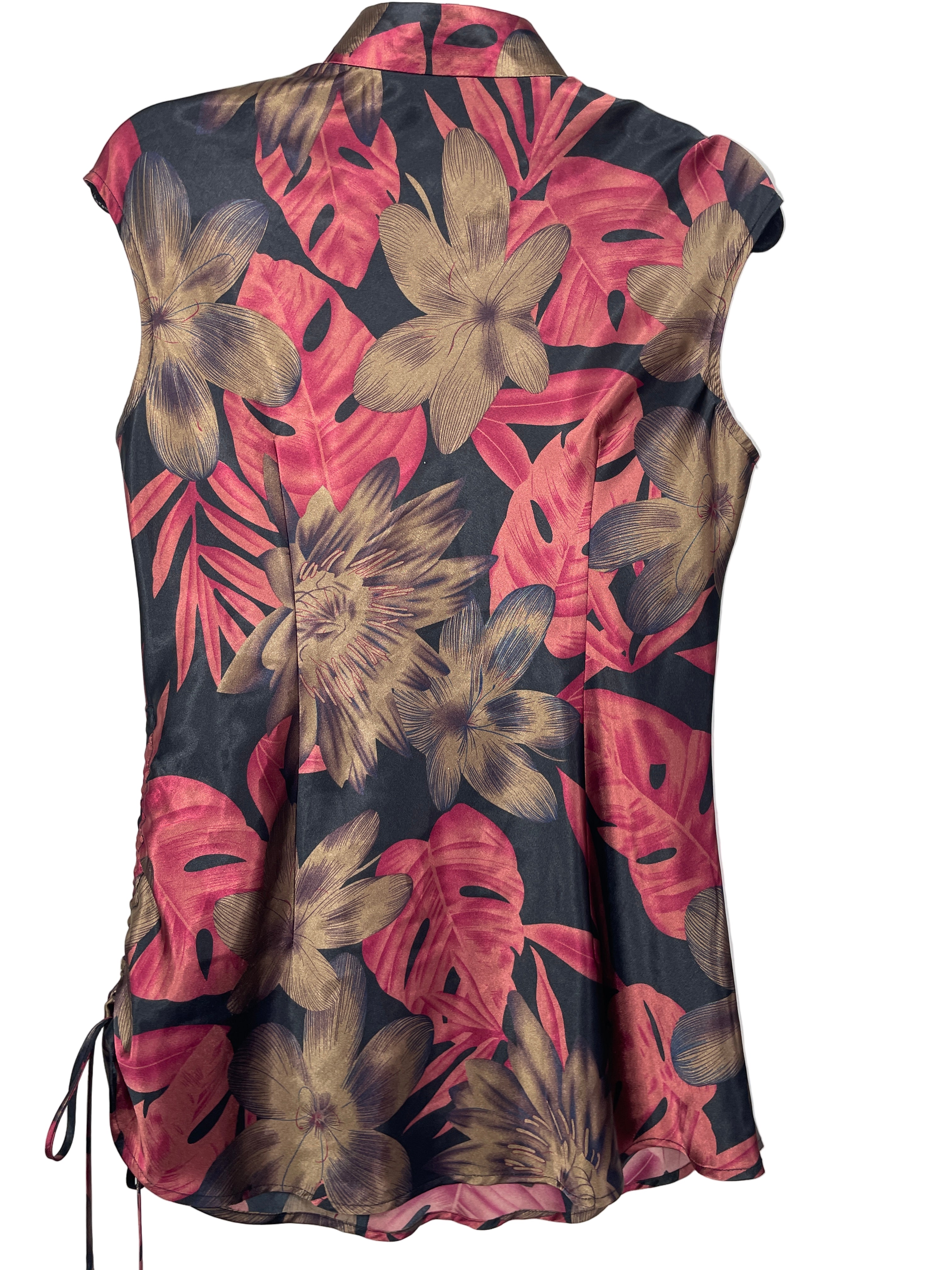 Back view of OCHI silk blouse showing floral pattern and side tie detail.
