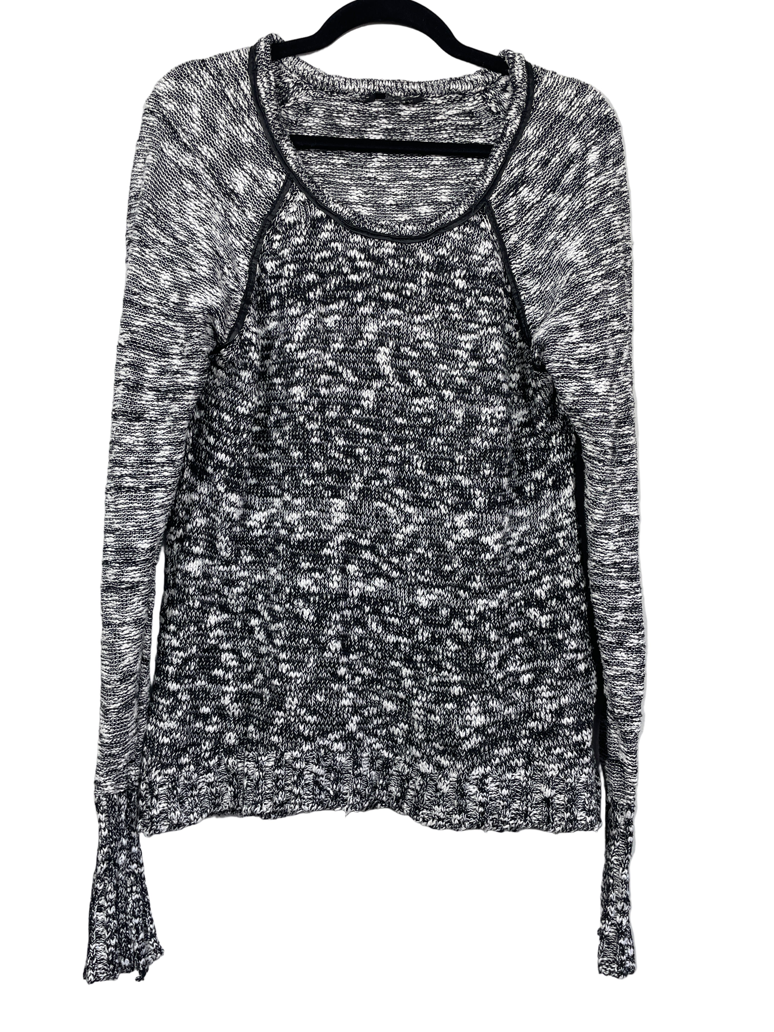 Front view of GUESS black and white marled knit sweater showing neckline and long sleeves.
