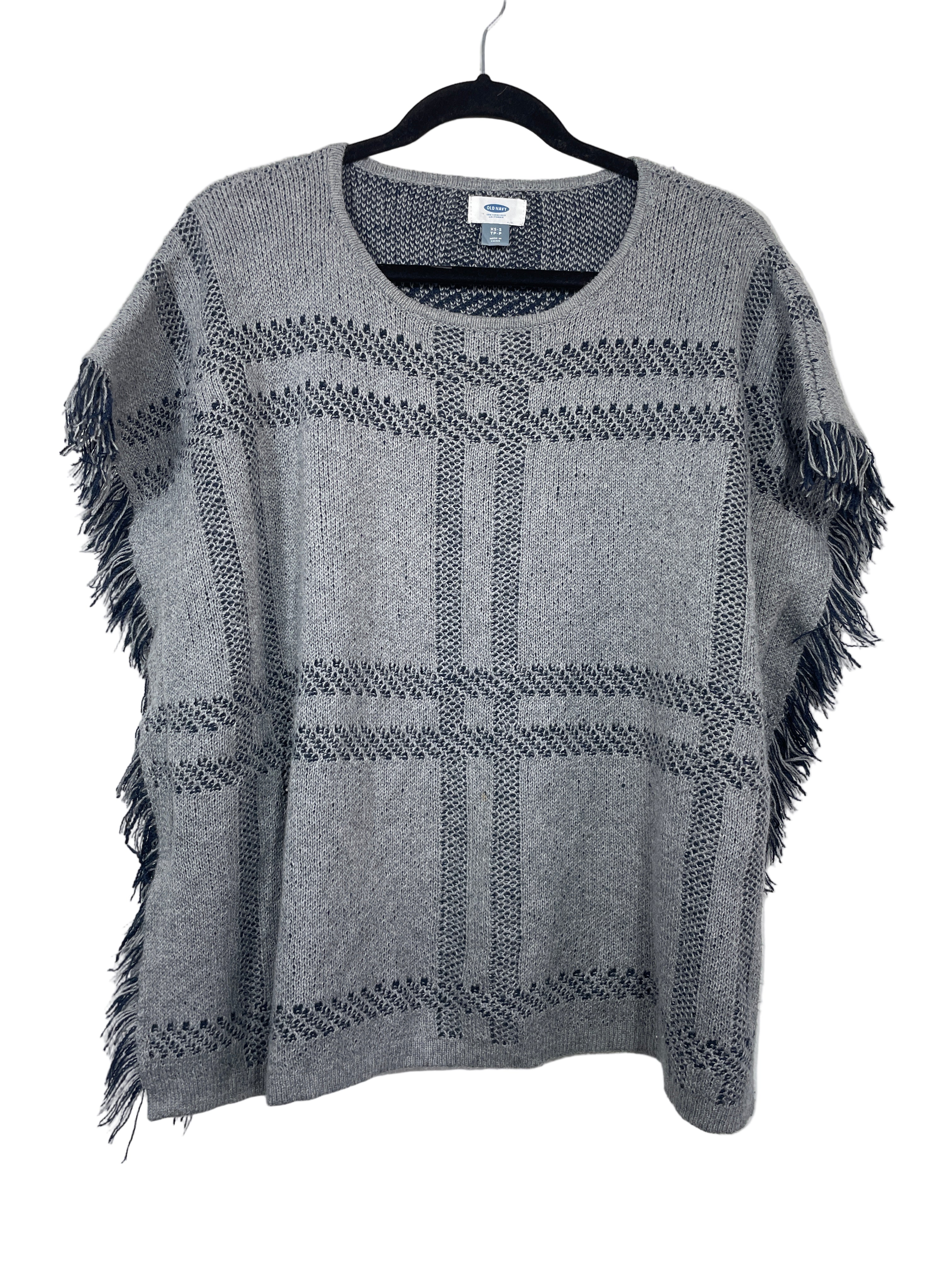 Front view of Old Navy grey and navy poncho sweater with plaid knit pattern and fringe trim.

