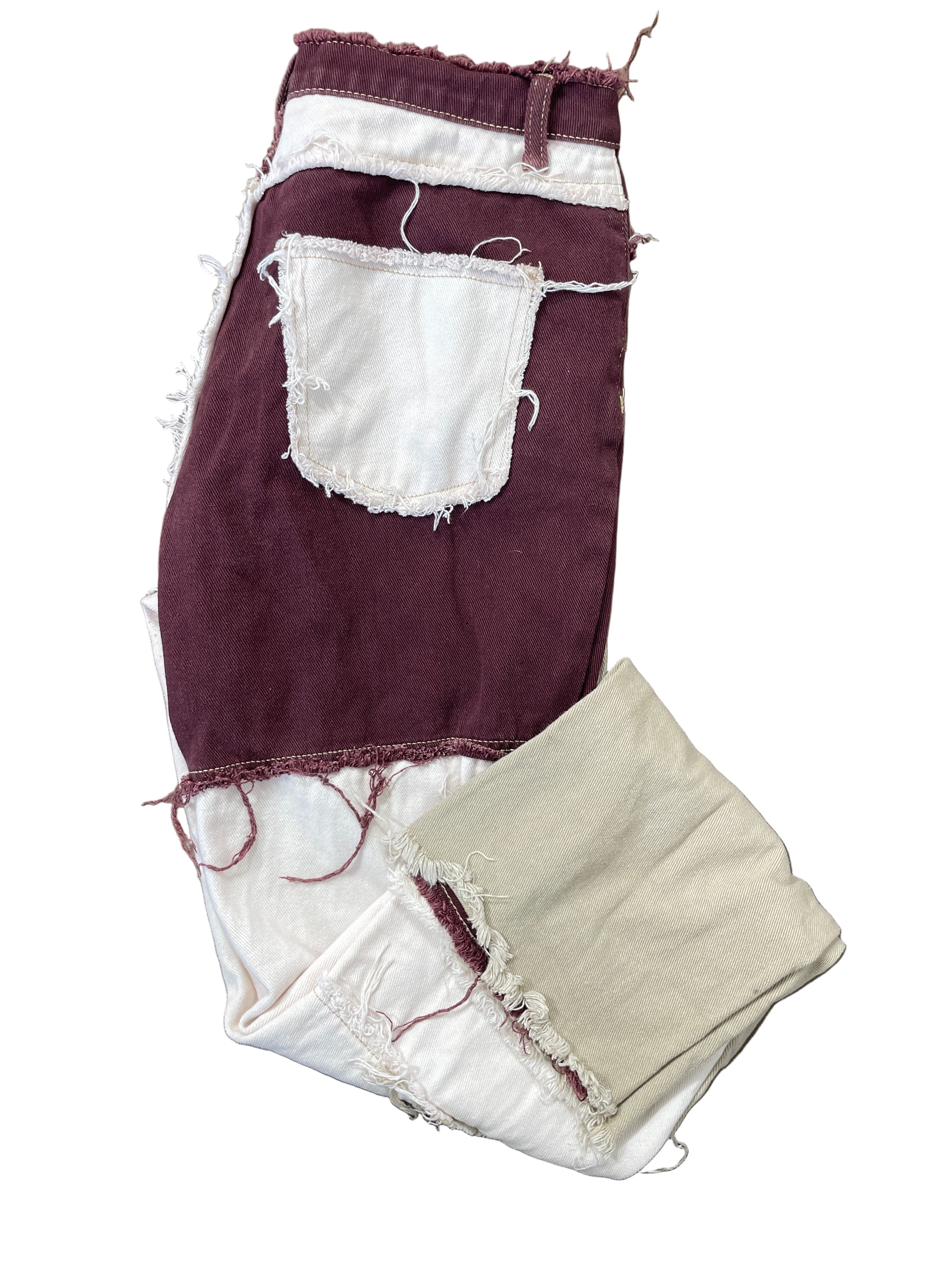 Folded view of SHEIN patchwork jeans showing frayed detailing and colourblock design
