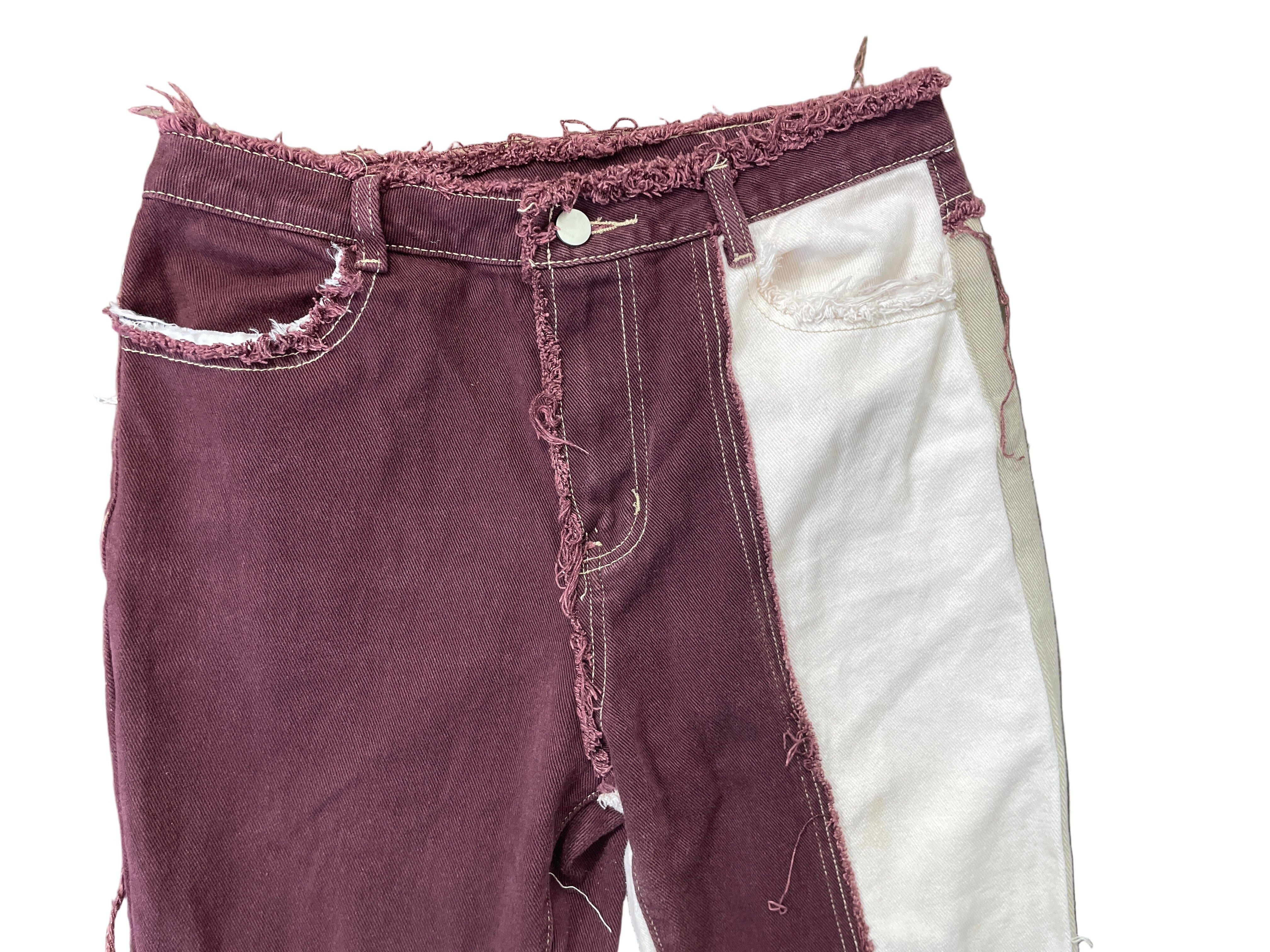 Front view showing raw hem waistband and asymmetric burgundy and cream patch layout
