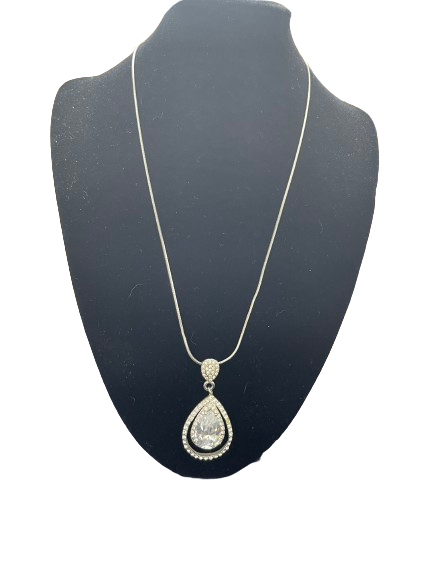 Necklace with a teardrop pendant on a black mannequin bust