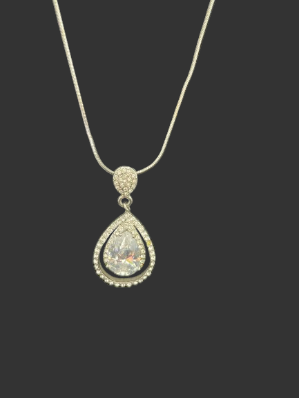 Teardrop-shaped crystal pendant on a chain against a black background