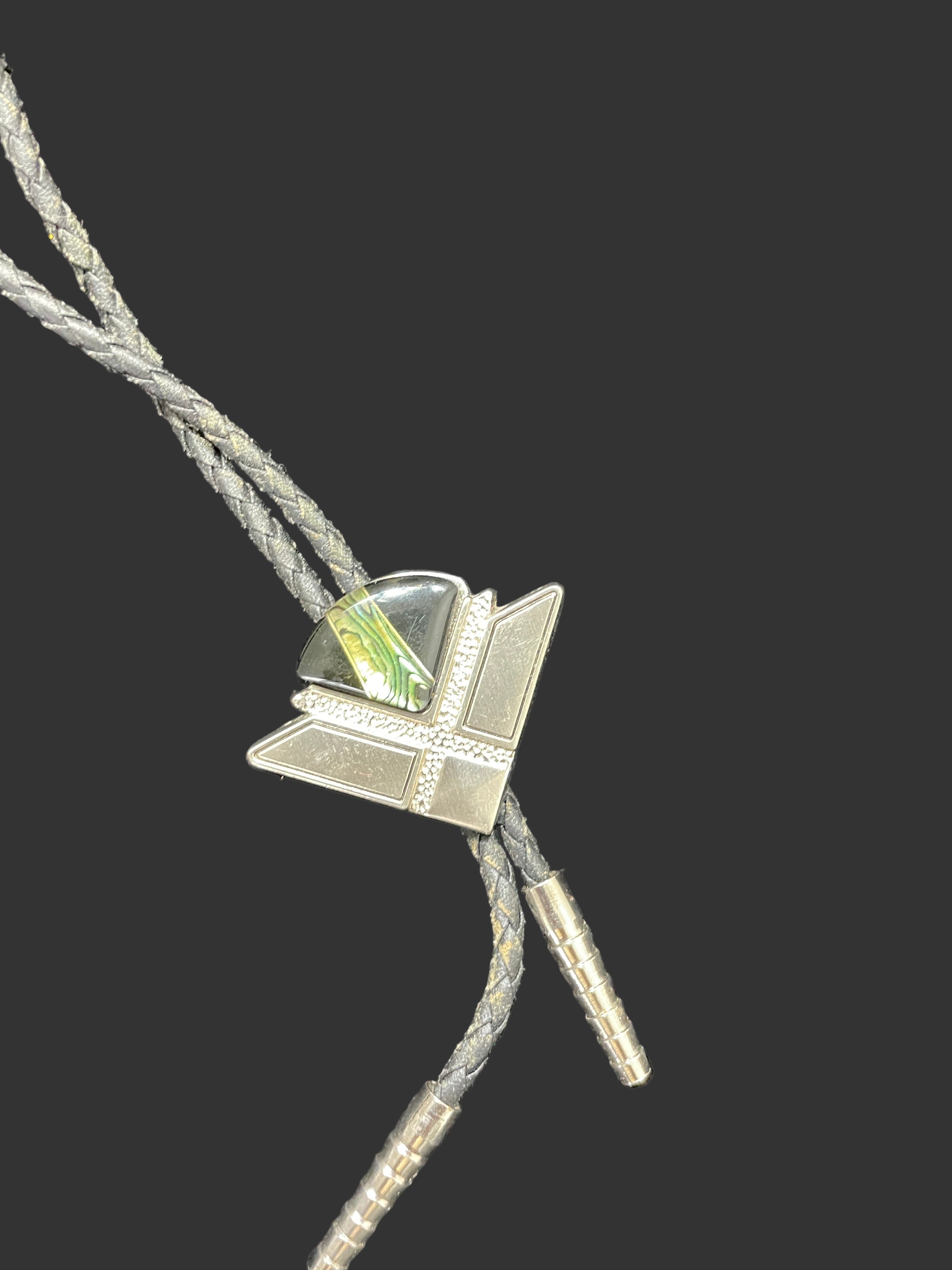 Close-up of silver bolo tie with green inlay