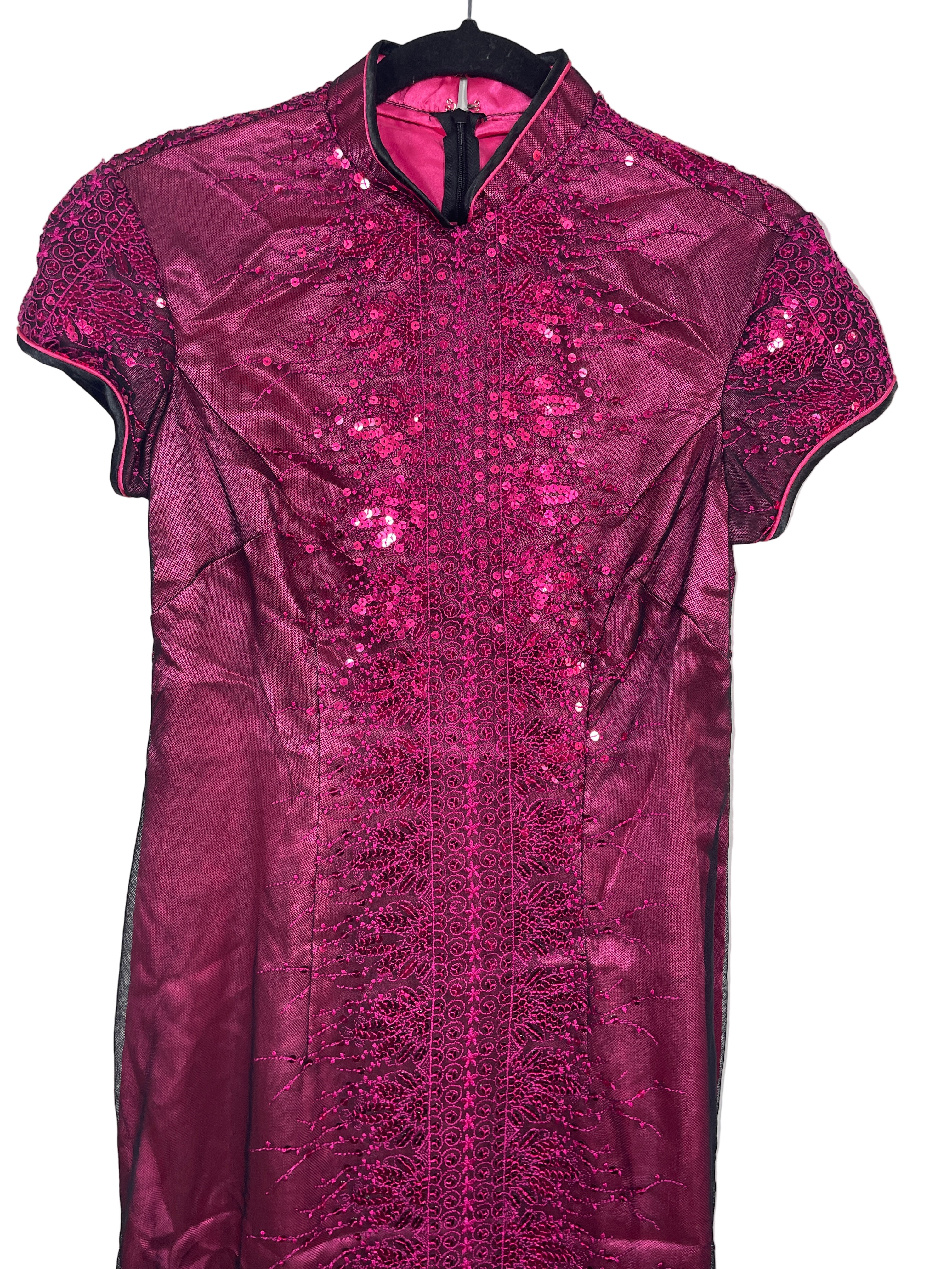 Close-up of bodice of dress showing sequin details and mandarin collar.
