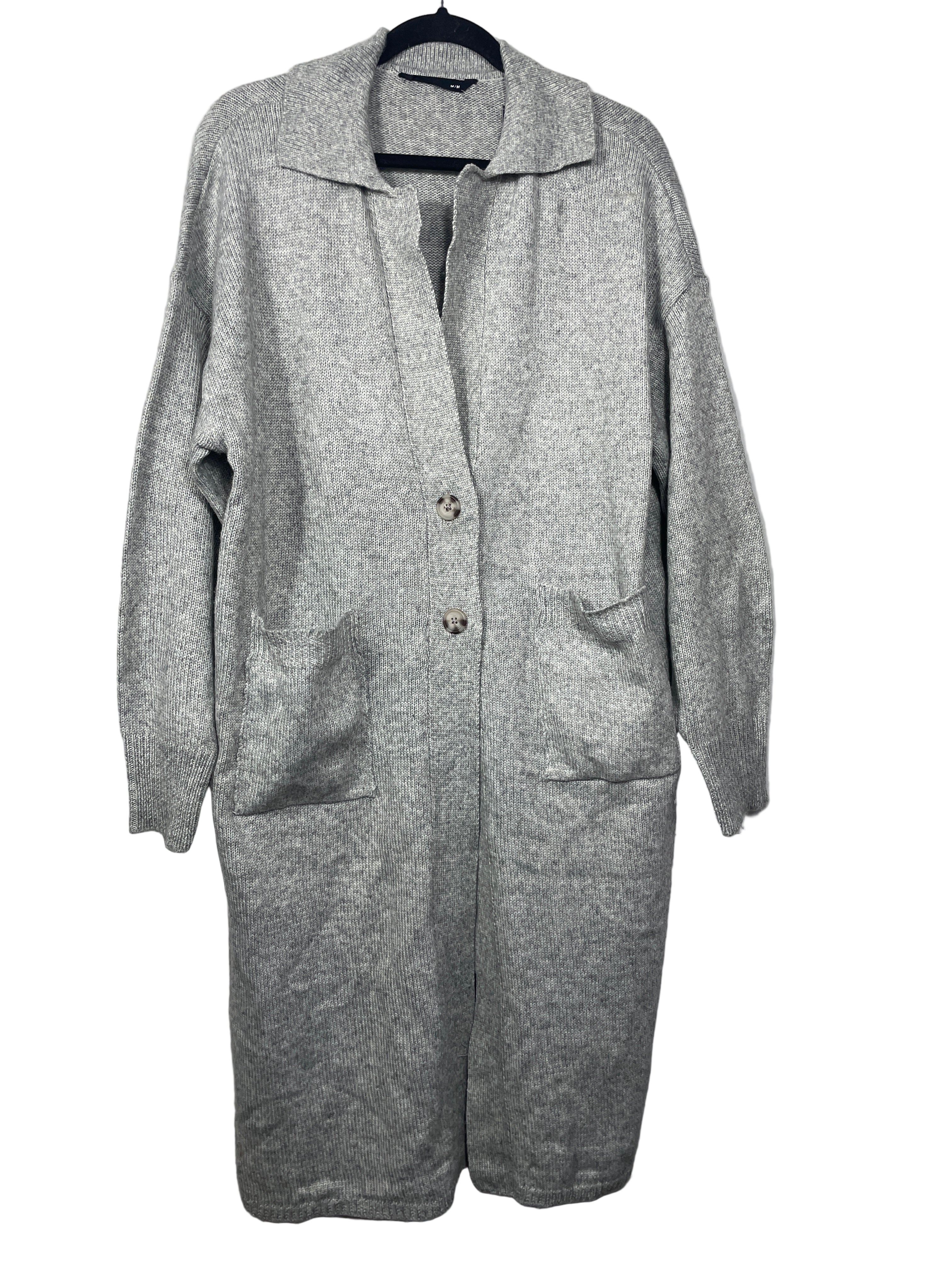 Bluenotes long grey knit cardigan with button front and large pockets hanging on hanger, front view.