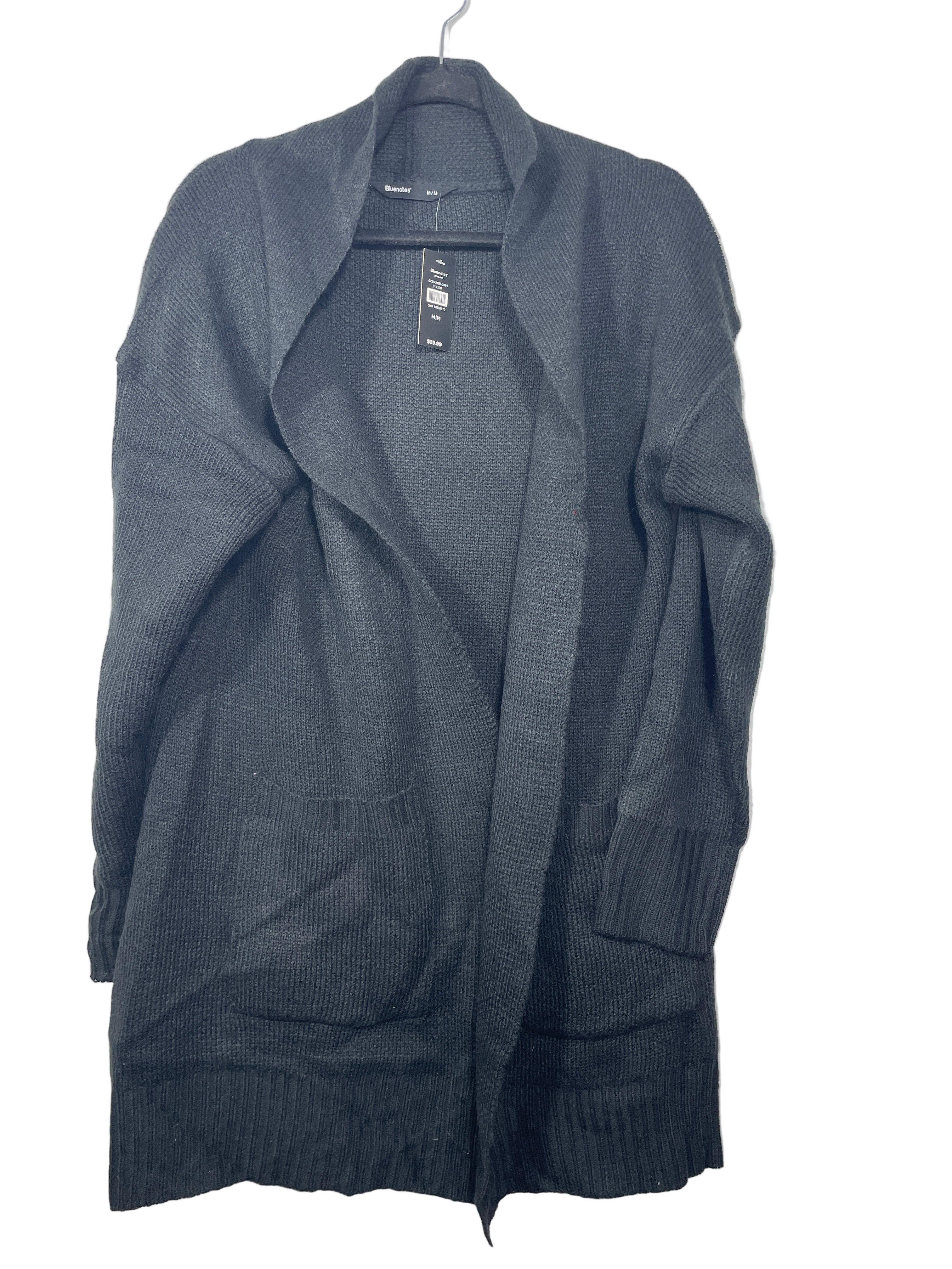 Bluenotes black open front cardigan with ribbed cuffs and front pockets hanging on hanger, front view.