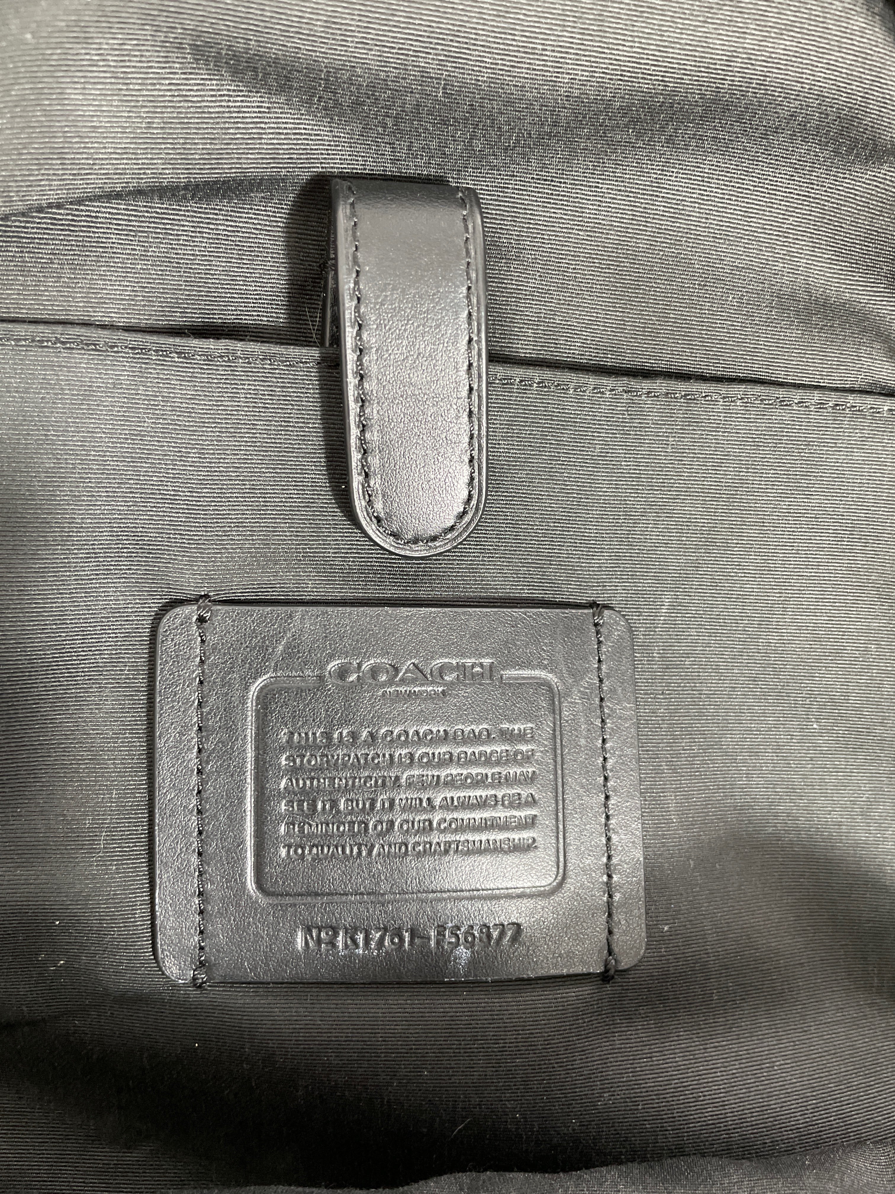 Close-up of a Coach label on a bag with a blurred background