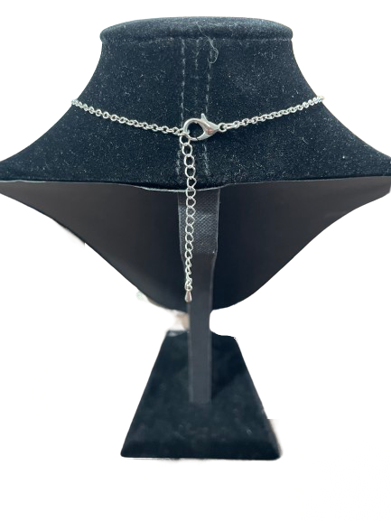 Silver chain necklace on a black velvet mannequin bust