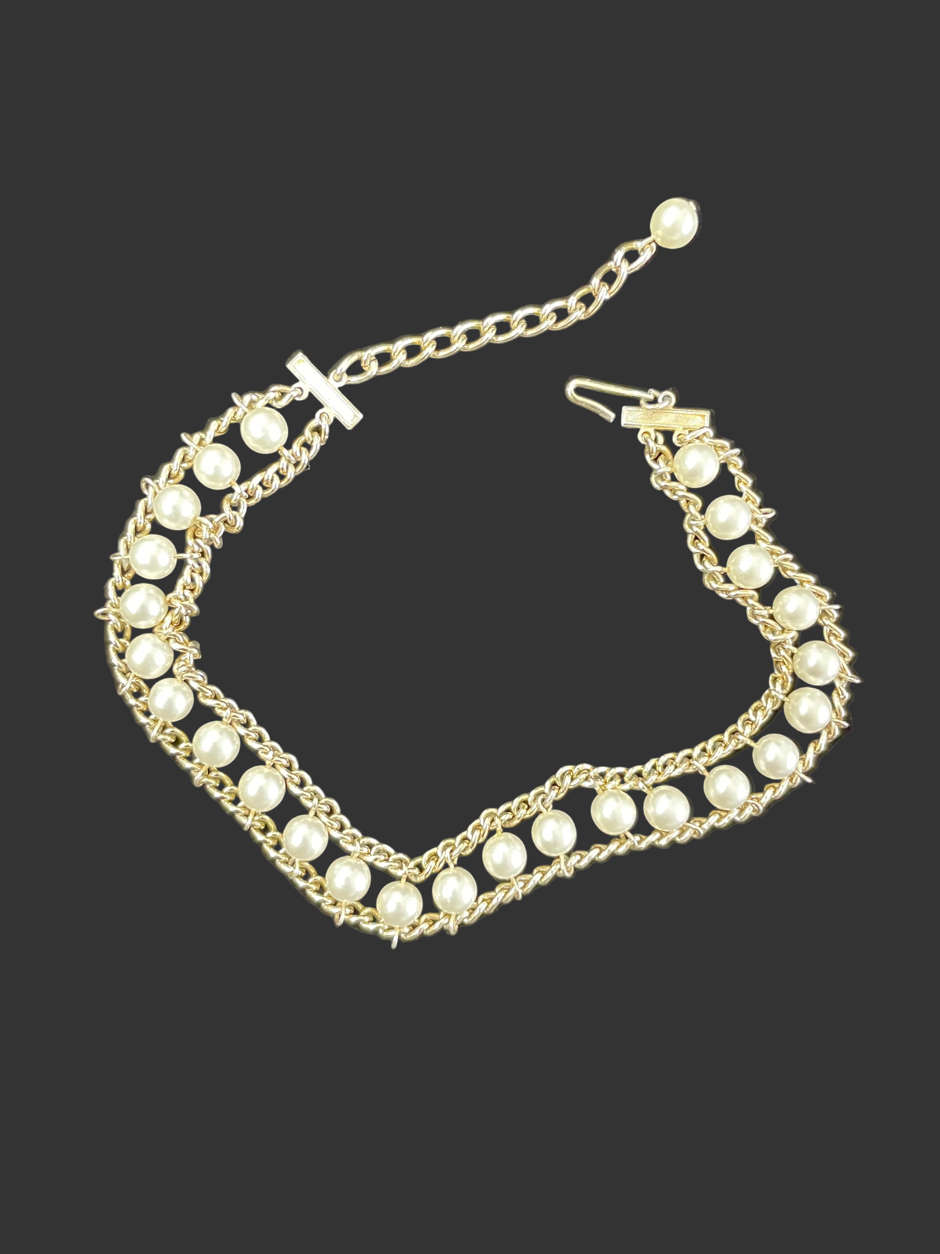 Faux pearl chain link choker necklace on display bust showing choker length and gold-tone chain design