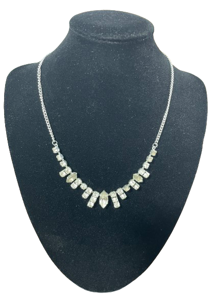 Rhinestone choker length costume necklace on display bust showing stone detailing along the front