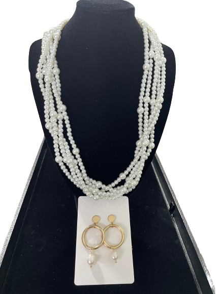 Five strand faux pearl necklace displayed on black bust with gold tone drop earrings