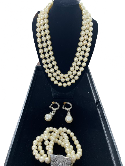 Vintage faux pearl three strand necklace with matching bracelet and clip-on earrings
